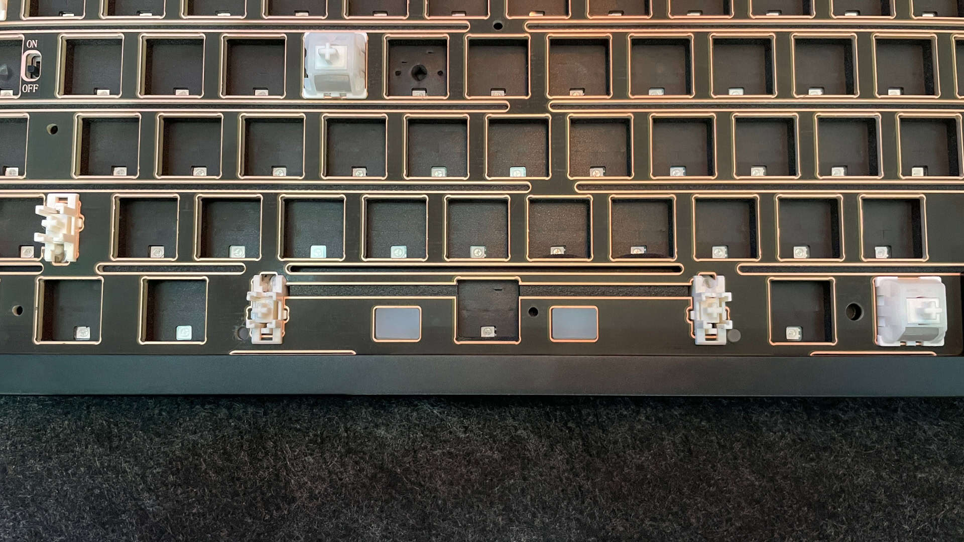 Close-up of the Weikav NUT65 mechanical keyboard’s spacebar area, showing LED diffusers and narrow cutout for the stabilizer.