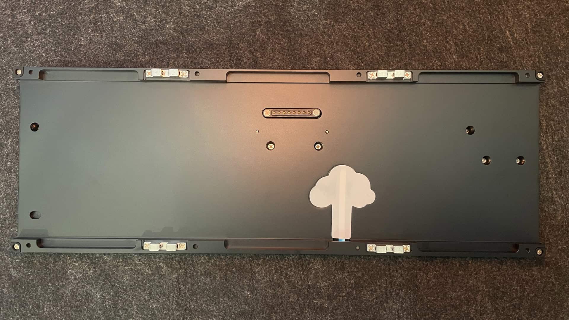 Internal side of the Weikav NUT65 bottom case showing the solid aluminum surface with no visible battery compartment.