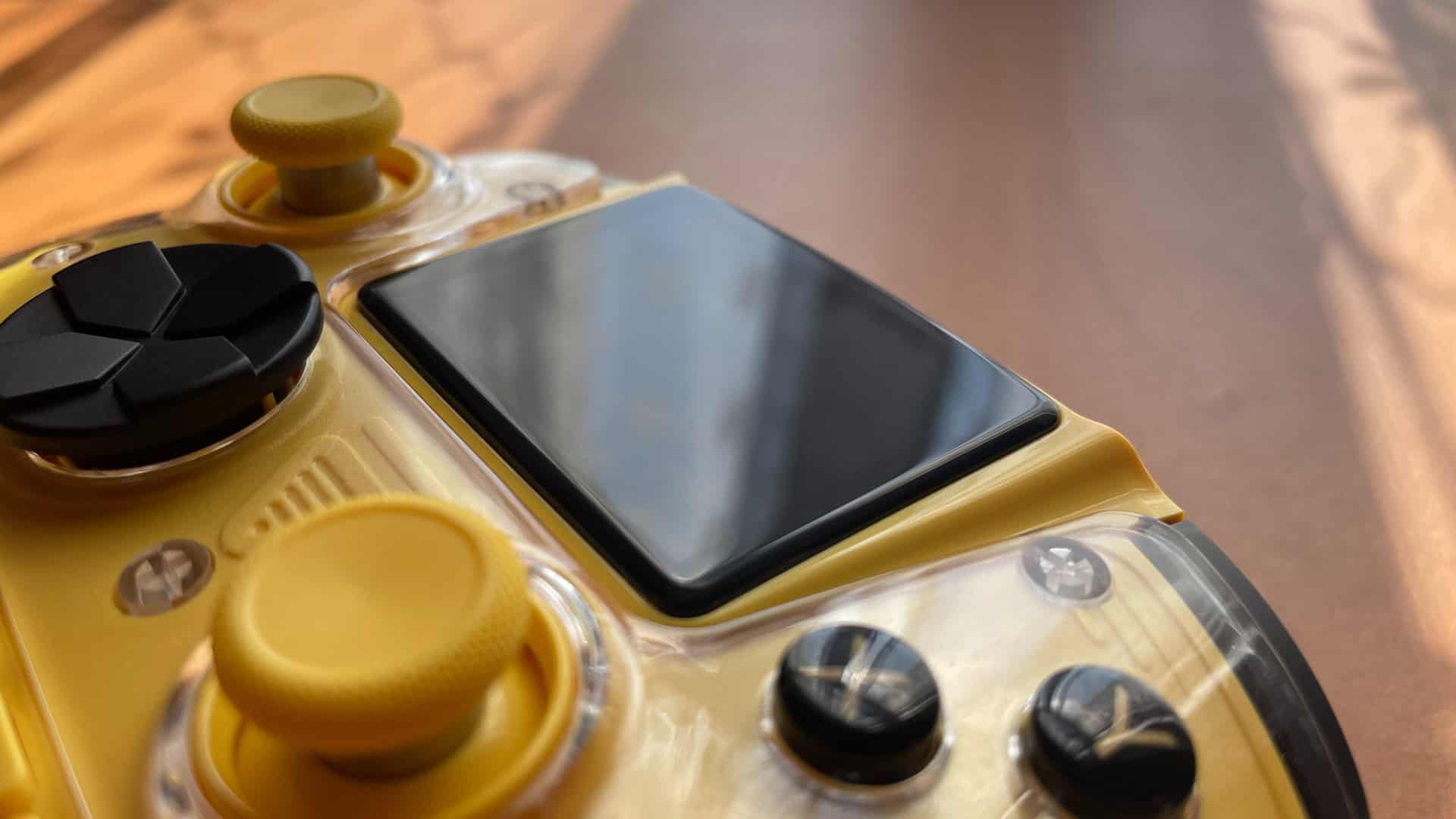 Close-up of the Anbernic RG G01 controller showing its 2.5D display with slightly curved edges and smooth glass finish