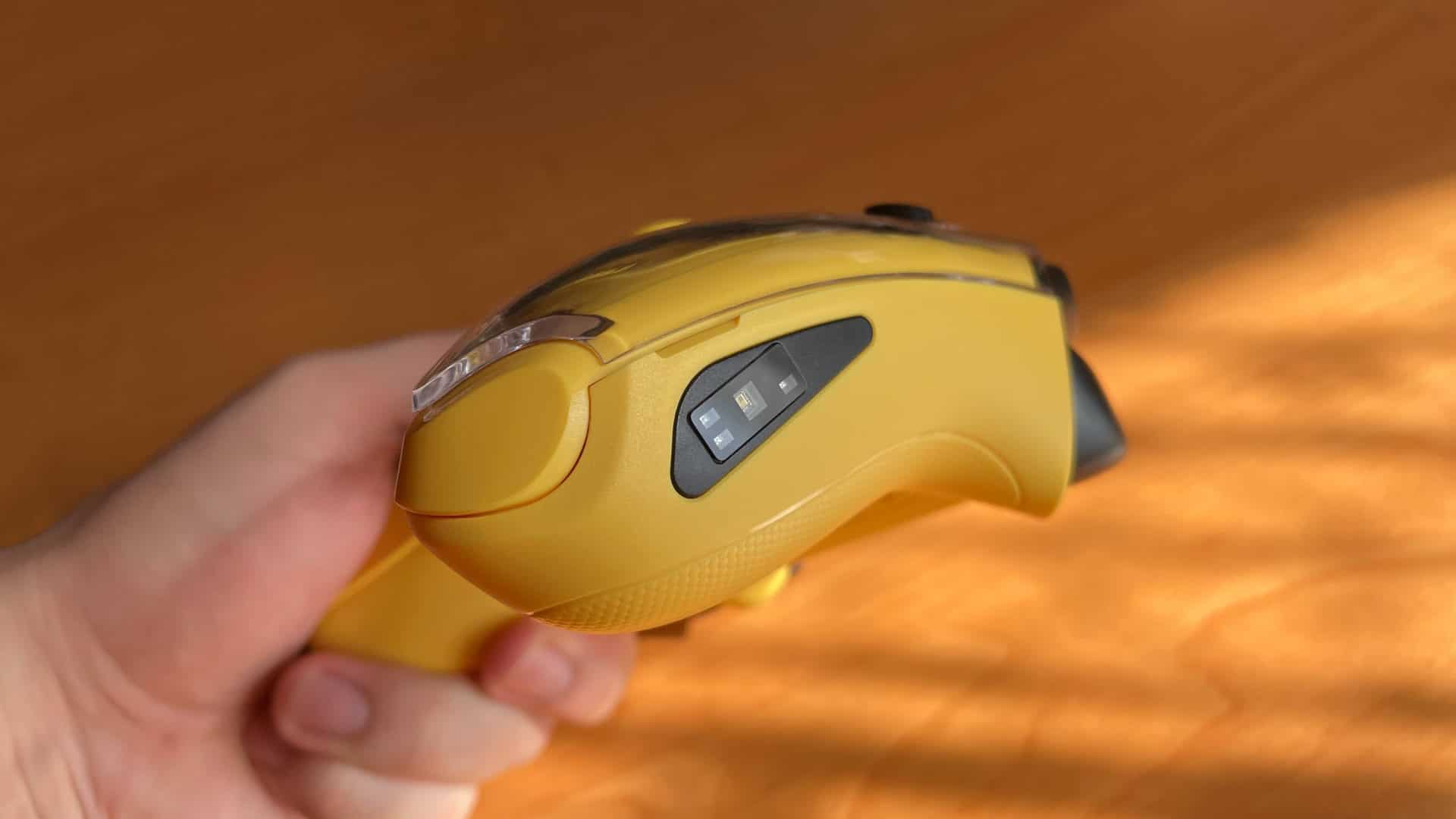 Close-up of the Anbernic RG G01 controller showing the heart rate sensors embedded in the grip