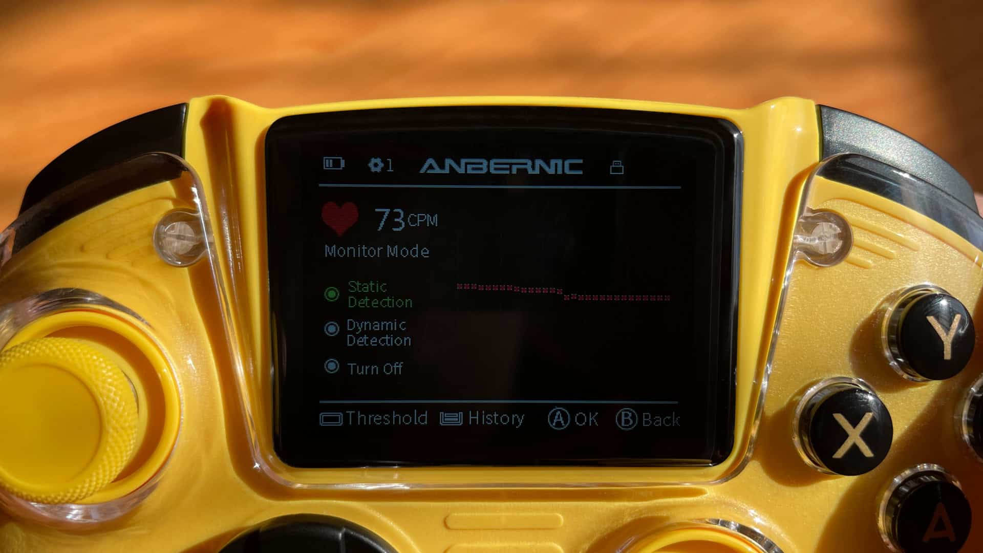 Close-up of the Anbernic RG G01 controller screen displaying heart rate measurement, highlighting the health monitoring feature