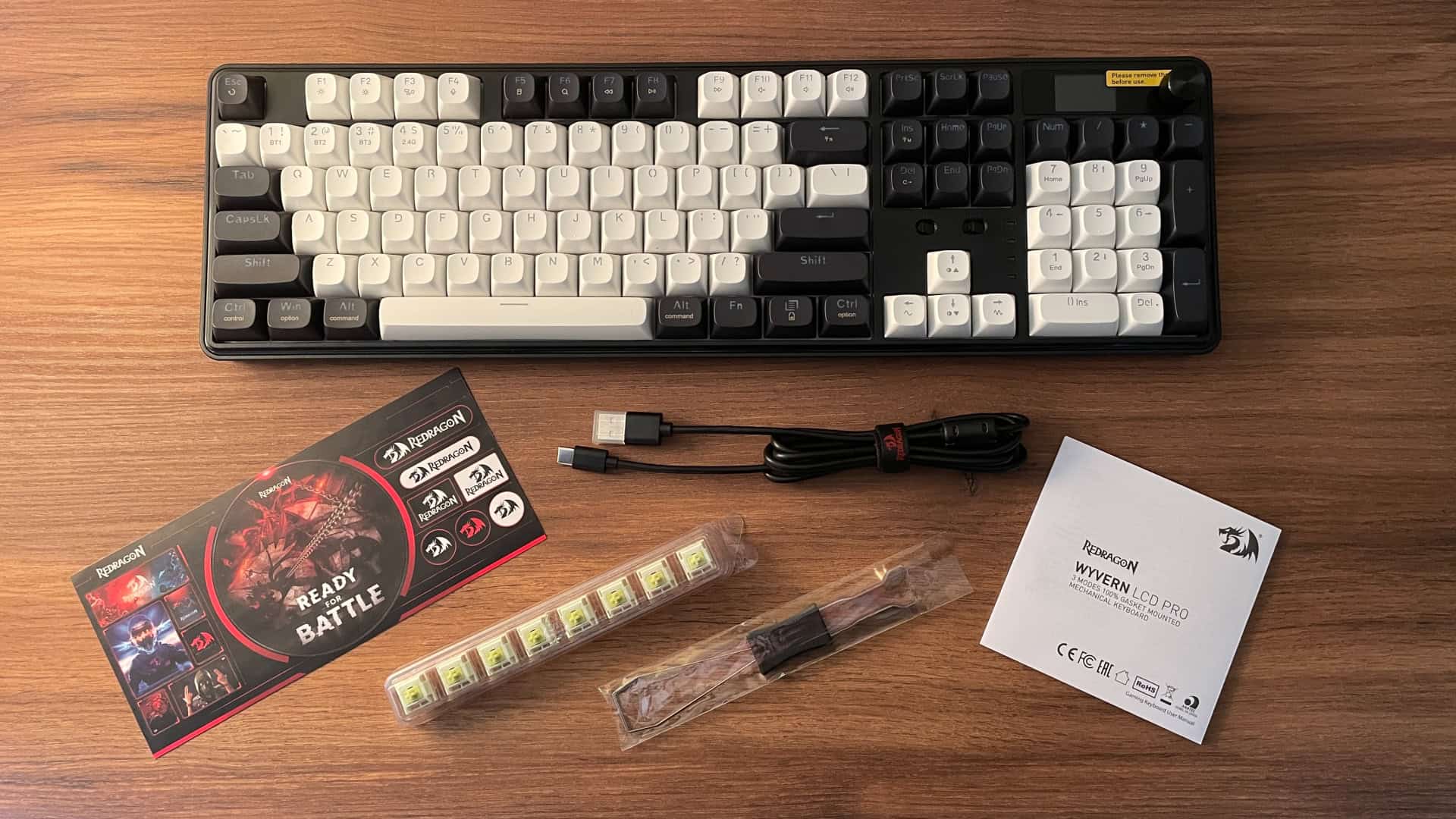 Full package contents of the Redragon Wyvern K761 Pro mechanical keyboard, including the keyboard, cable, and included accessories.