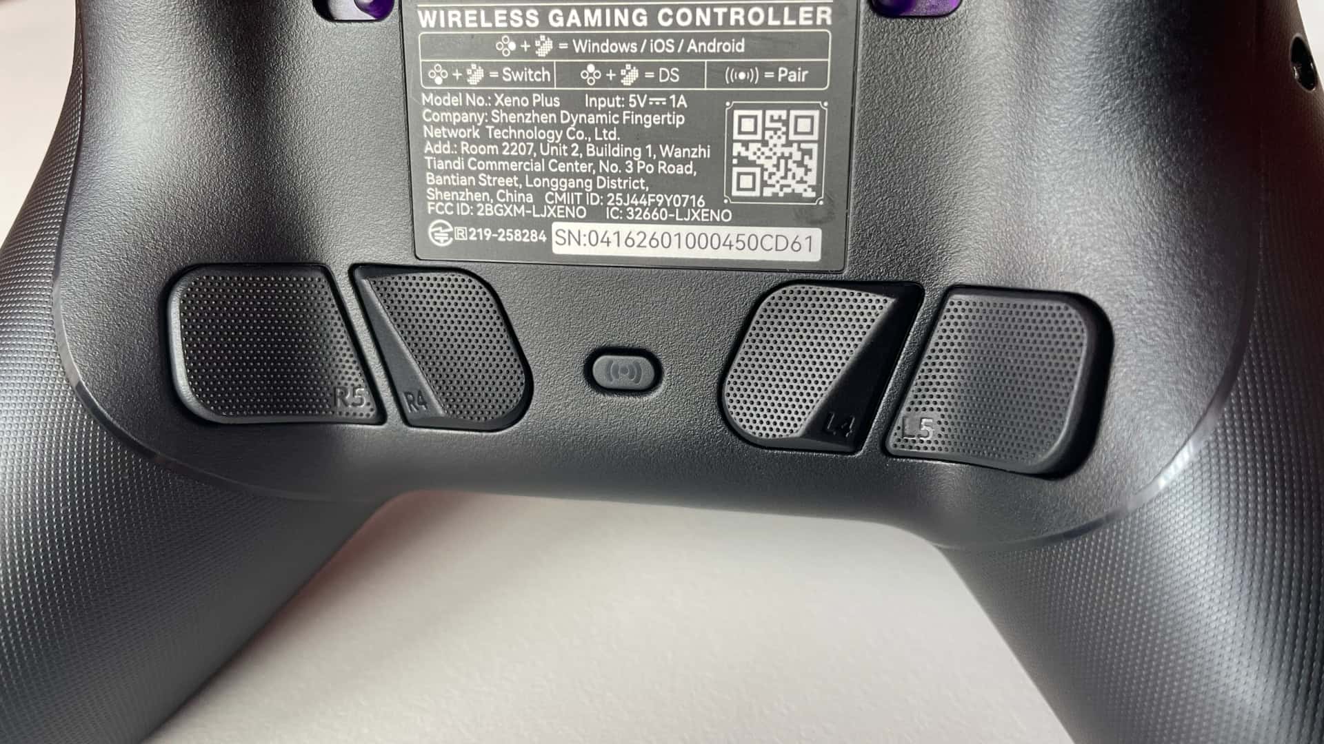 Detailed close-up of the back buttons on the Leadjoy Xeno Plus gaming controller, showing their placement and textured surface for improved tactile feedback.