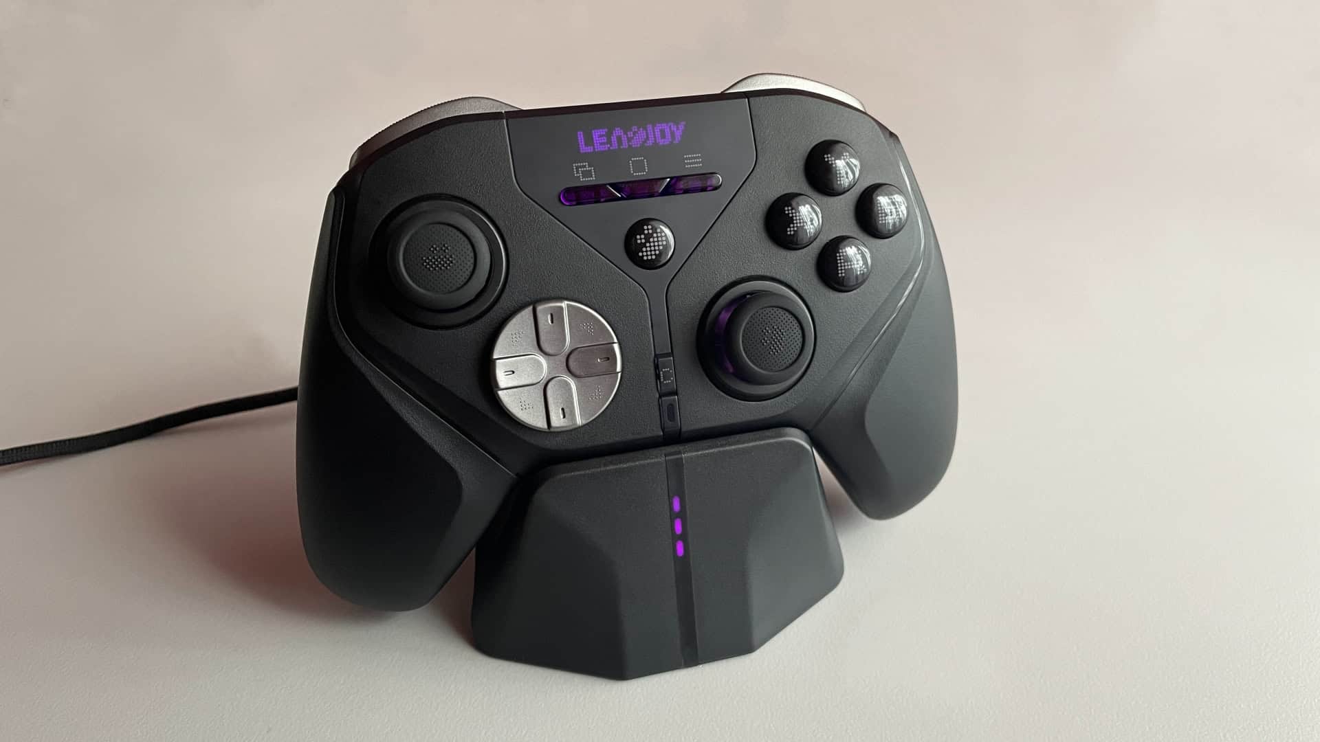 The Leadjoy Xeno Plus controller placed in its charging dock, with blinking LED indicators showing the current battery charging level status.