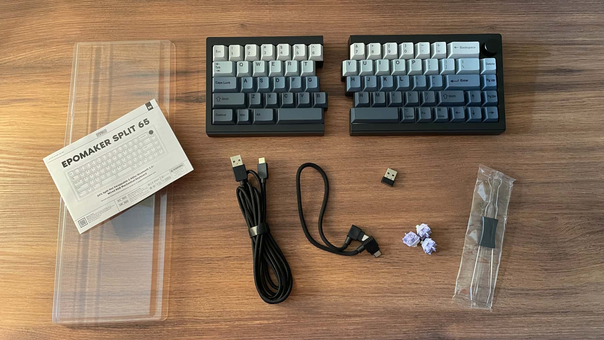 Photo showing the Epomaker Split65 mechanical keyboard package contents, including keyboard halves, cables, and accessories.