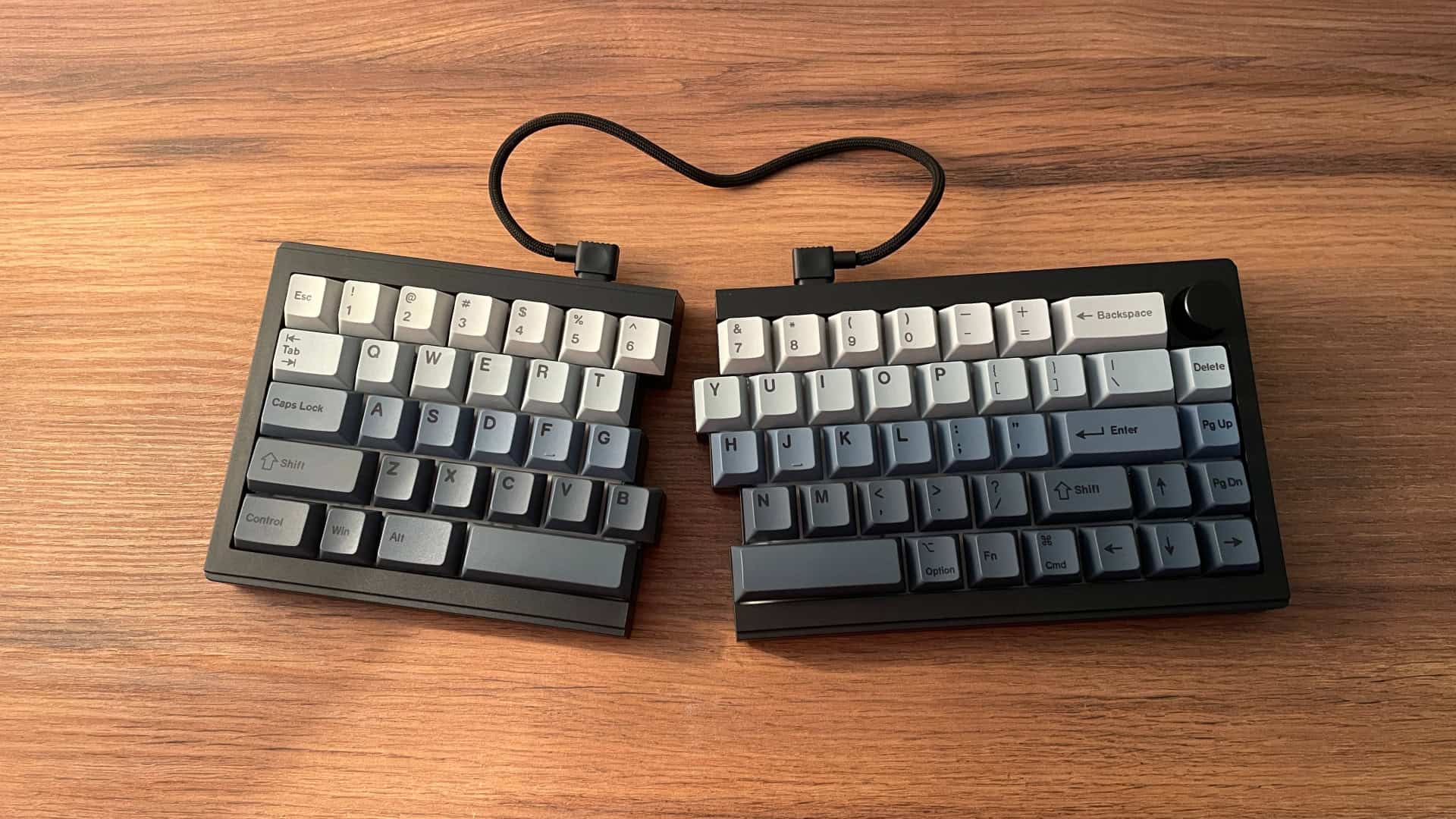 Epomaker Split65 halves angled inward in an Alice-style ergonomic setup.