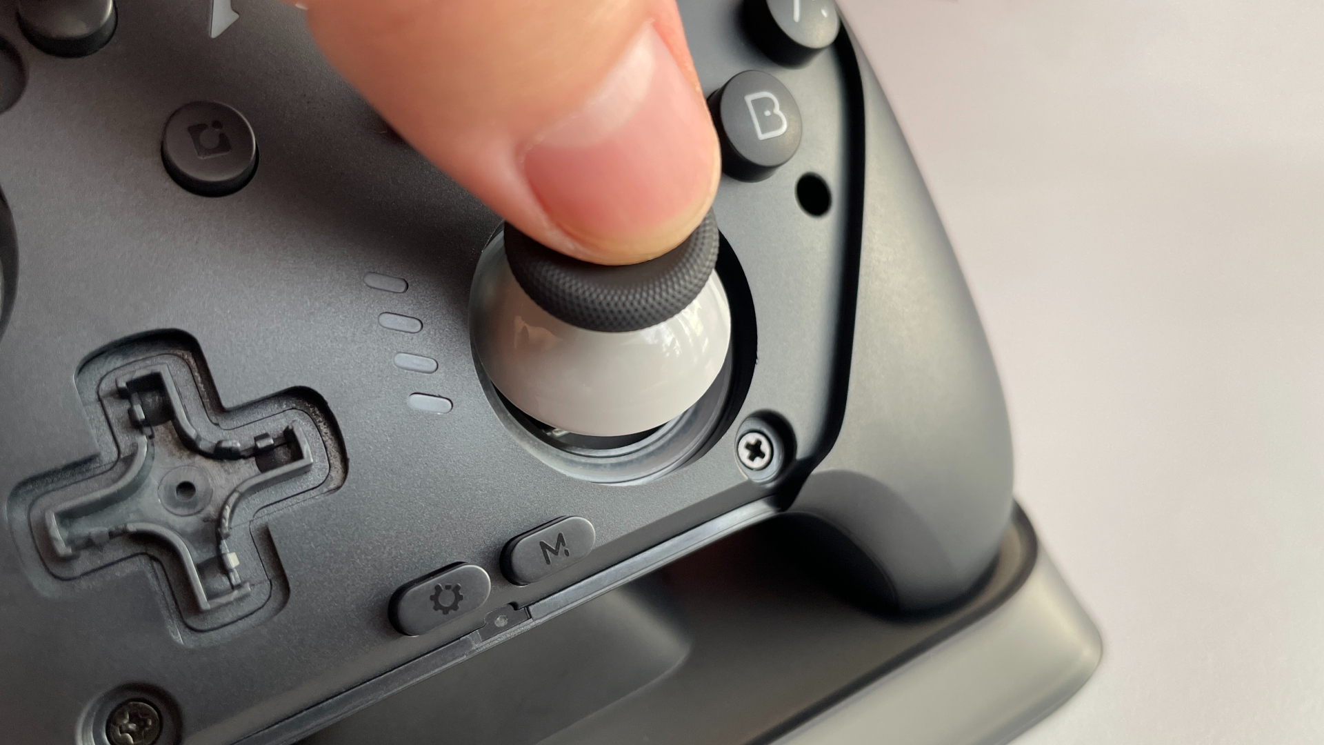 Close-up photo of the Mobapad Chitu 2 HD Silent Edition joystick mechanism showing the internal liquid silicone rubber tracks used for smooth and silent analog stick movement.