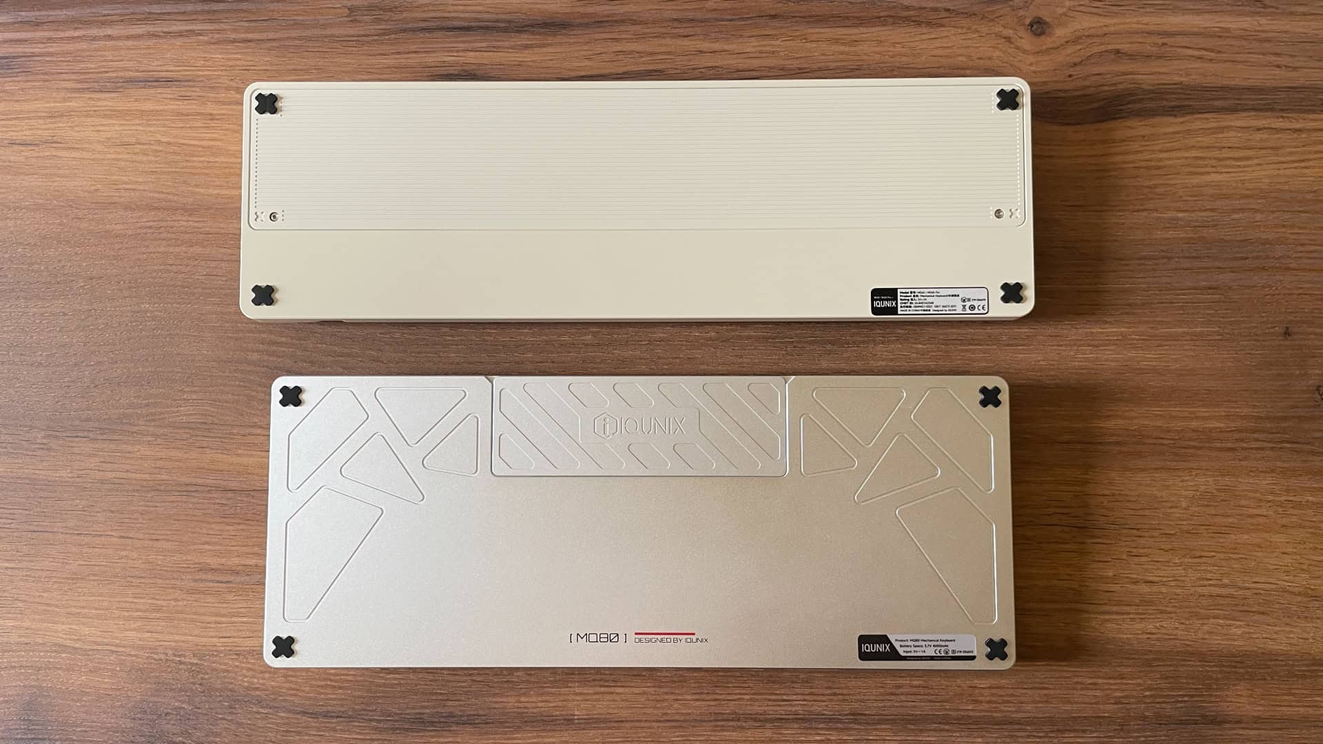 Bottom view comparison of the IQUNIX Magi65 Pro and IQUNIX MQ80 mechanical keyboards, both shown upside down to showcase their underside case design and construction details.