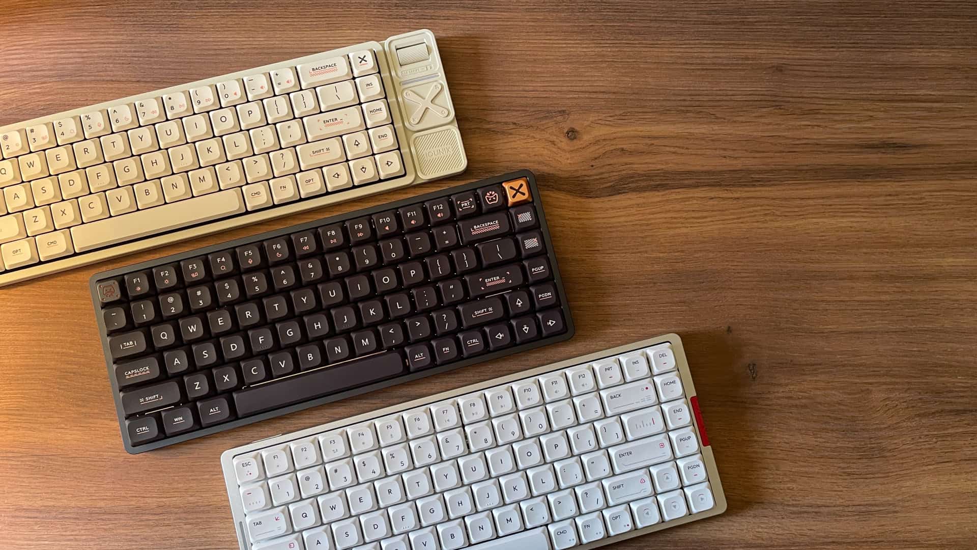 Side-by-side comparison of three IQUNIX mechanical keyboards: Magi75, Magi65 Pro, and MQ80, shown together to highlight their design differences and overall layout variations.