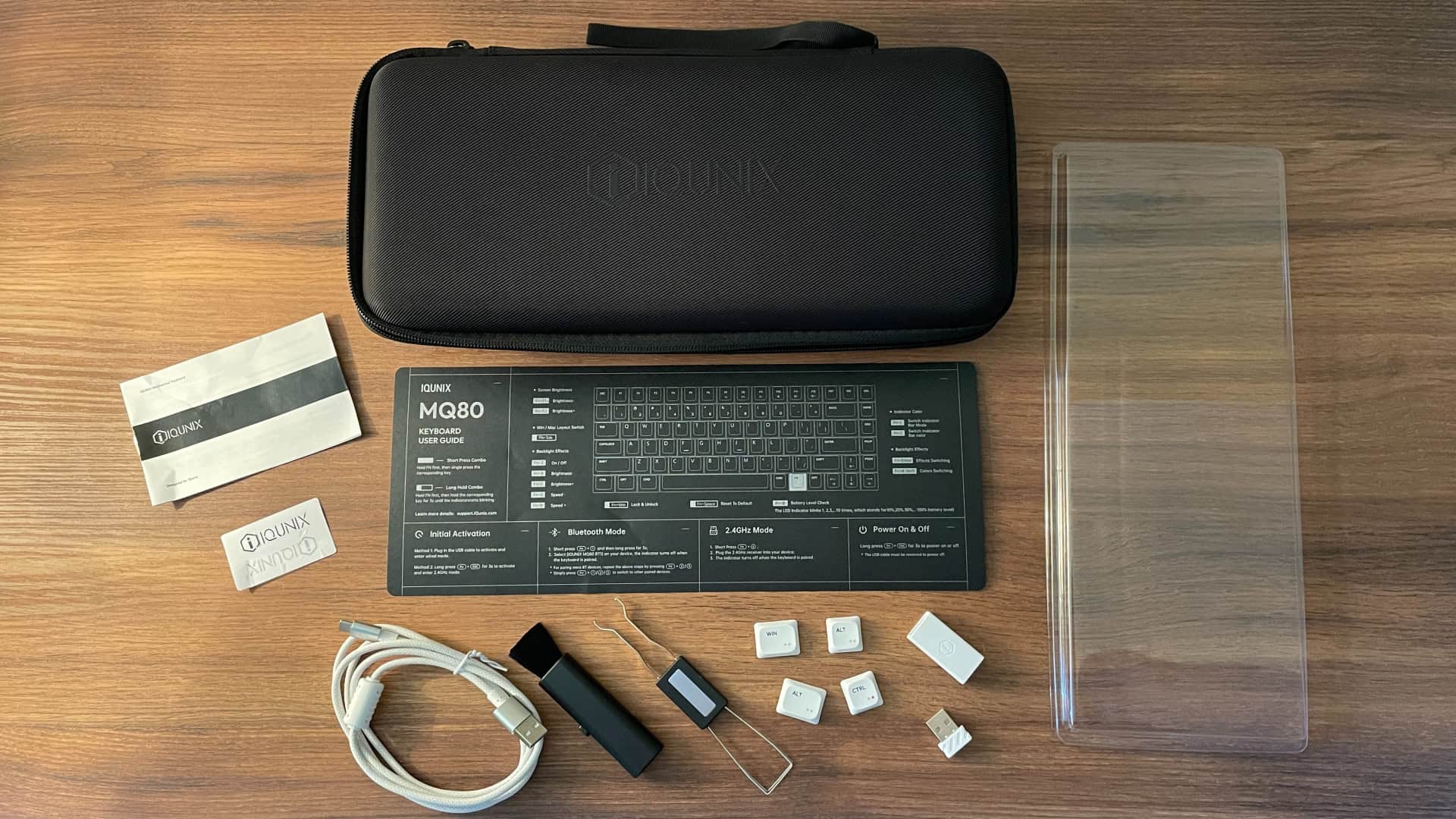 Full package contents of the IQUNIX MQ80 mechanical keyboard, showing all included items from the standard retail kit.