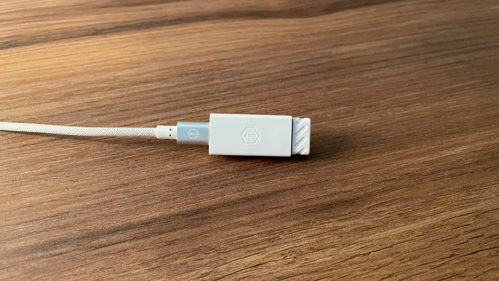 IQUNIX MQ80 wireless dongle inserted into a converter for more stable connectivity.