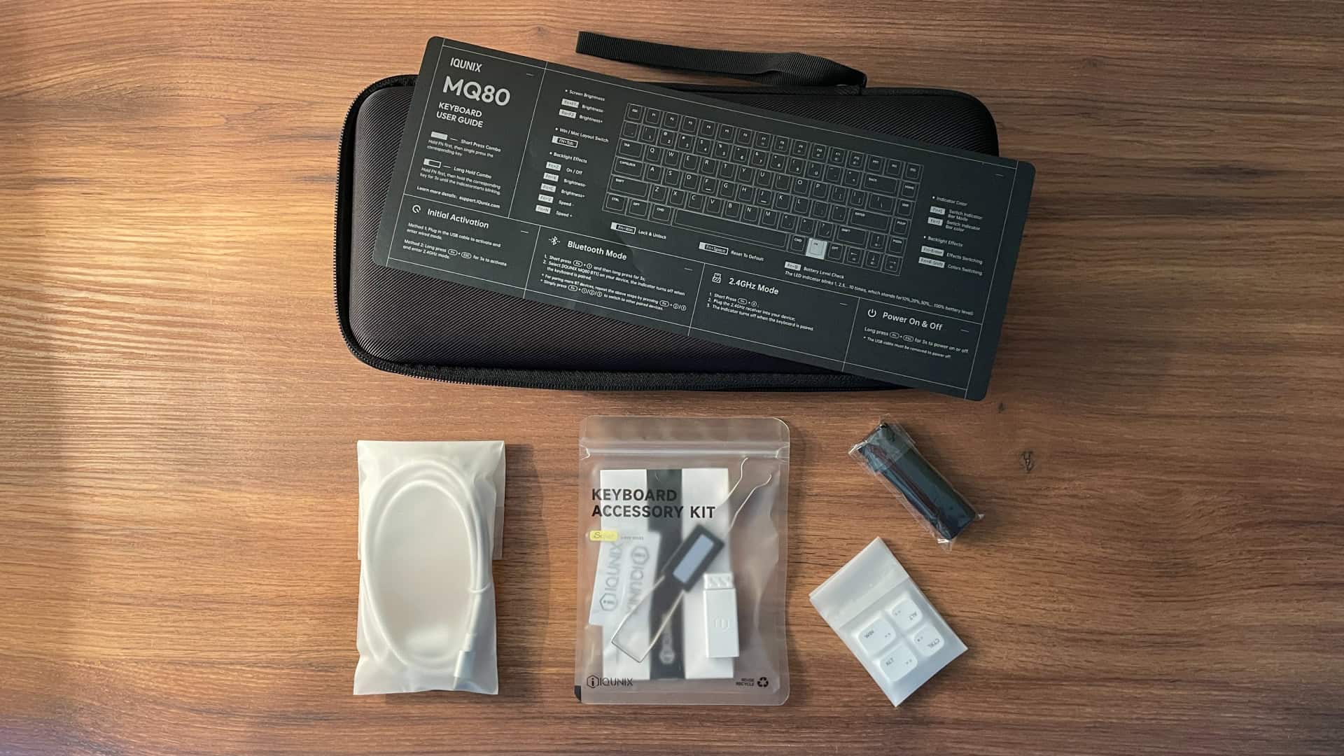 All included accessories for the IQUNIX MQ80 mechanical keyboard, shown packaged in plastic bags, including cables, tools, and other components from the keyboard kit.