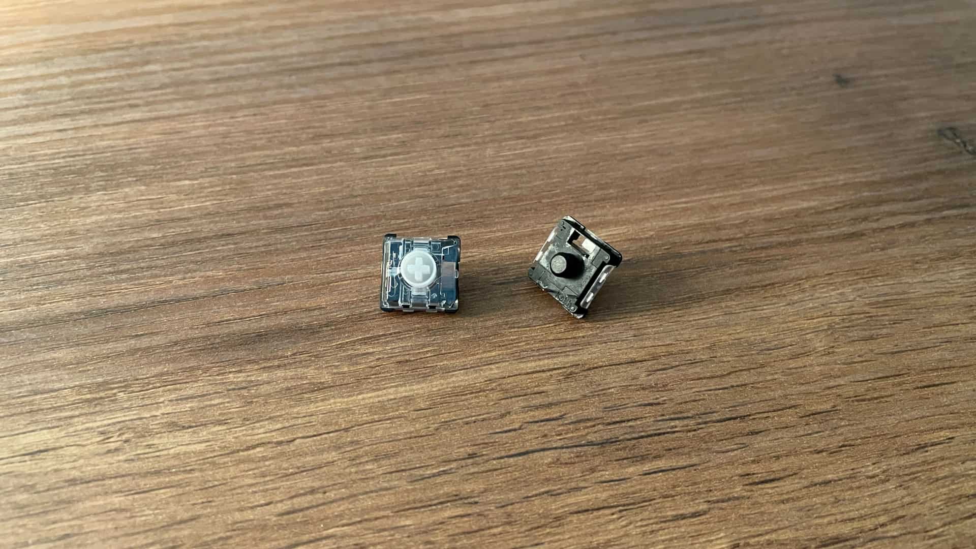 Close-up of Kailh POM Gold Red mechanical switches on the IQUNIX MQ80 keyboard, highlighting their construction and materials.