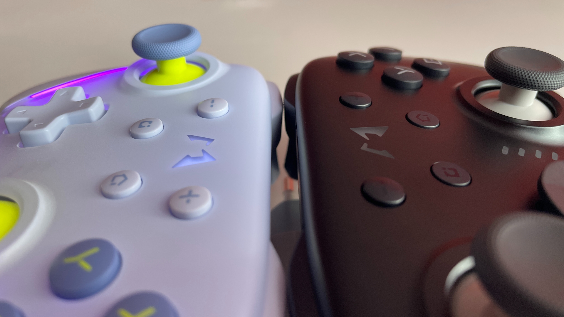 Comparison photo showing both Mobapad Chitu 2 HD and Mobapad Chitu 2 HD Silent Edition controllers side by side, highlighting the difference in system button design: the original model features a mix of flush and slightly raised buttons, while the Silent Edition has all four system buttons uniformly raised above the controller body.