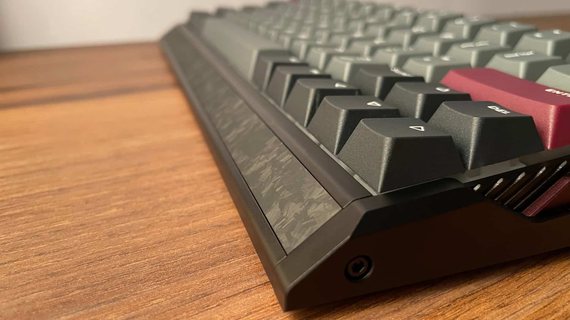 Close-up of the IQUNIX EV63 mechanical keyboard front section highlighting fully rounded transitions, smooth edges, and a refined ergonomic finish with no sharp corners.