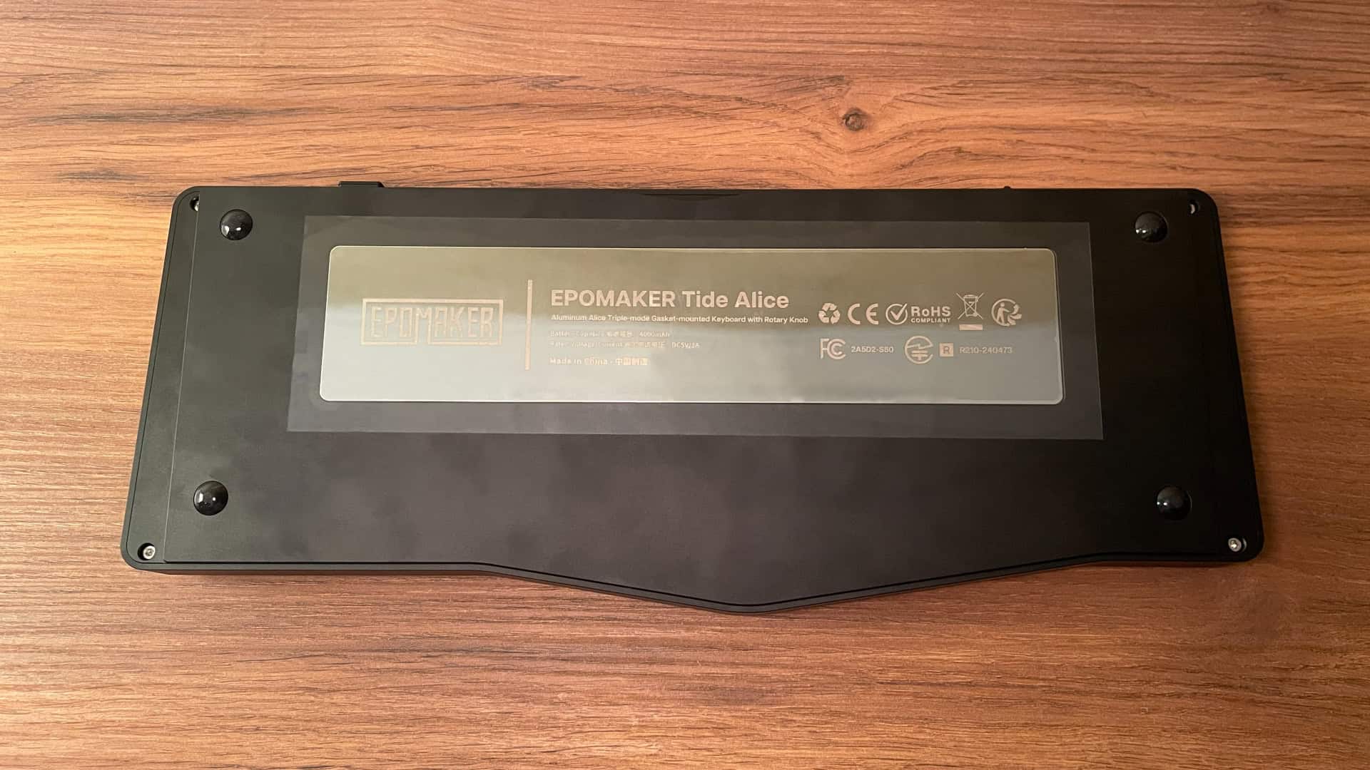 Bottom view of the Epomaker Tide Alice mechanical keyboard, showcasing the stainless steel weight integrated into the underside of the aluminum case.