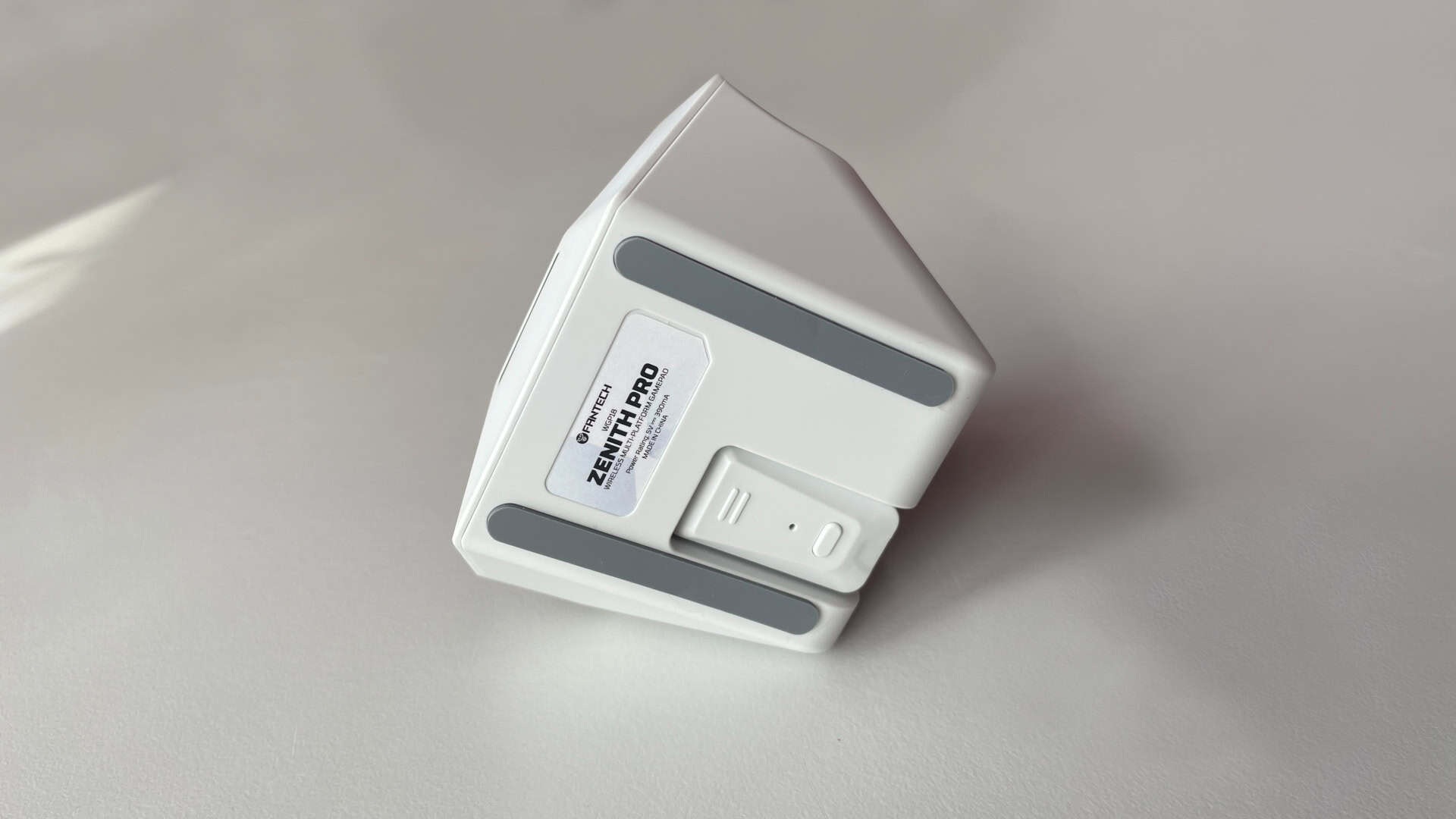 Close-up view of the underside of the Fantech Zenith Pro charging dock, showing the dedicated recessed compartment with the 2.4GHz USB wireless receiver inserted flush into the housing.