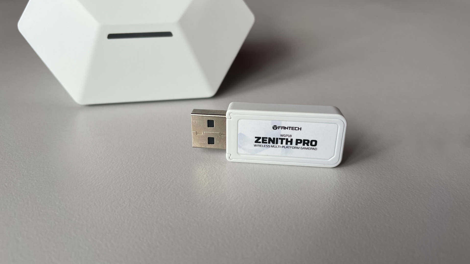 2.4GHz USB wireless dongle included with the Fantech Zenith Pro controller, shown as a small receiver for low-latency connection.