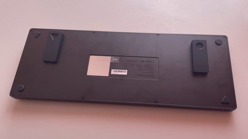 Underside view of the ATK Yogo 75 Pro showing the magnetic feet positioned on the keyboard base to demonstrate how they attach.