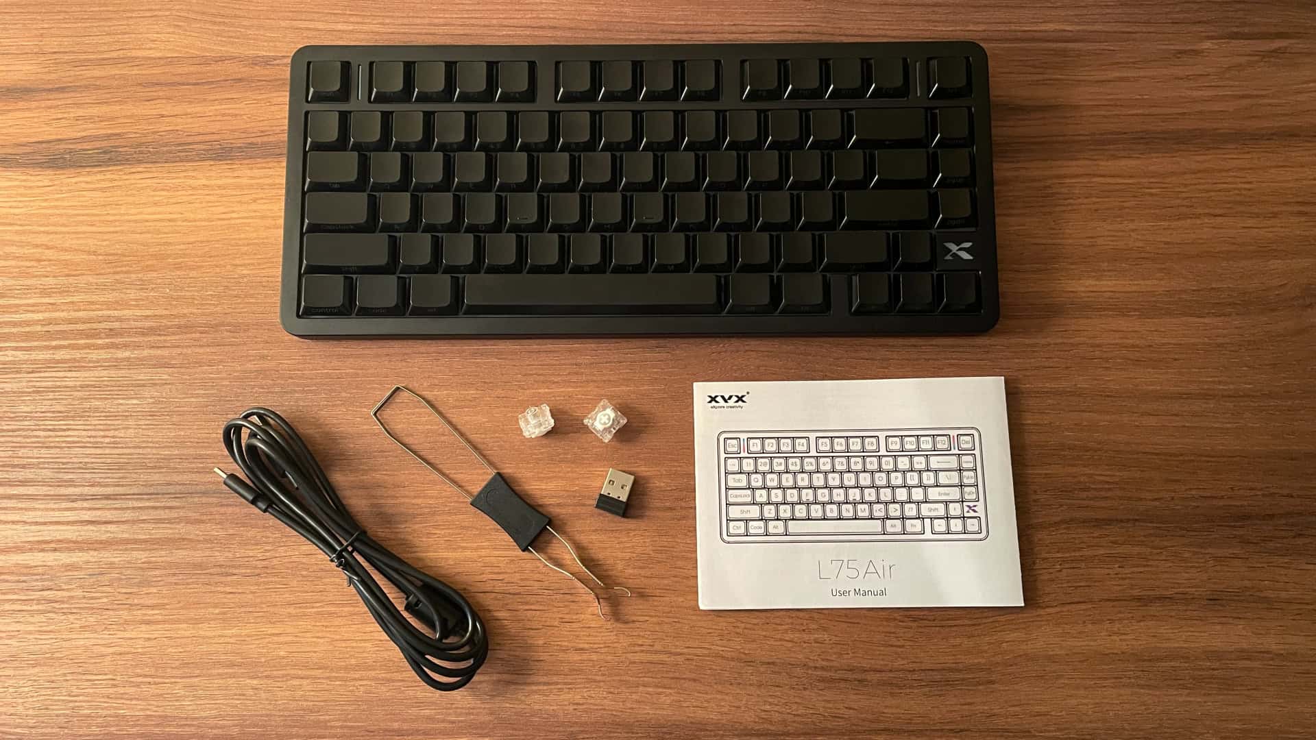 The XVX L75 Air low-profile mechanical keyboard package with the keyboard, accessories, and included items arranged for a product review overview.