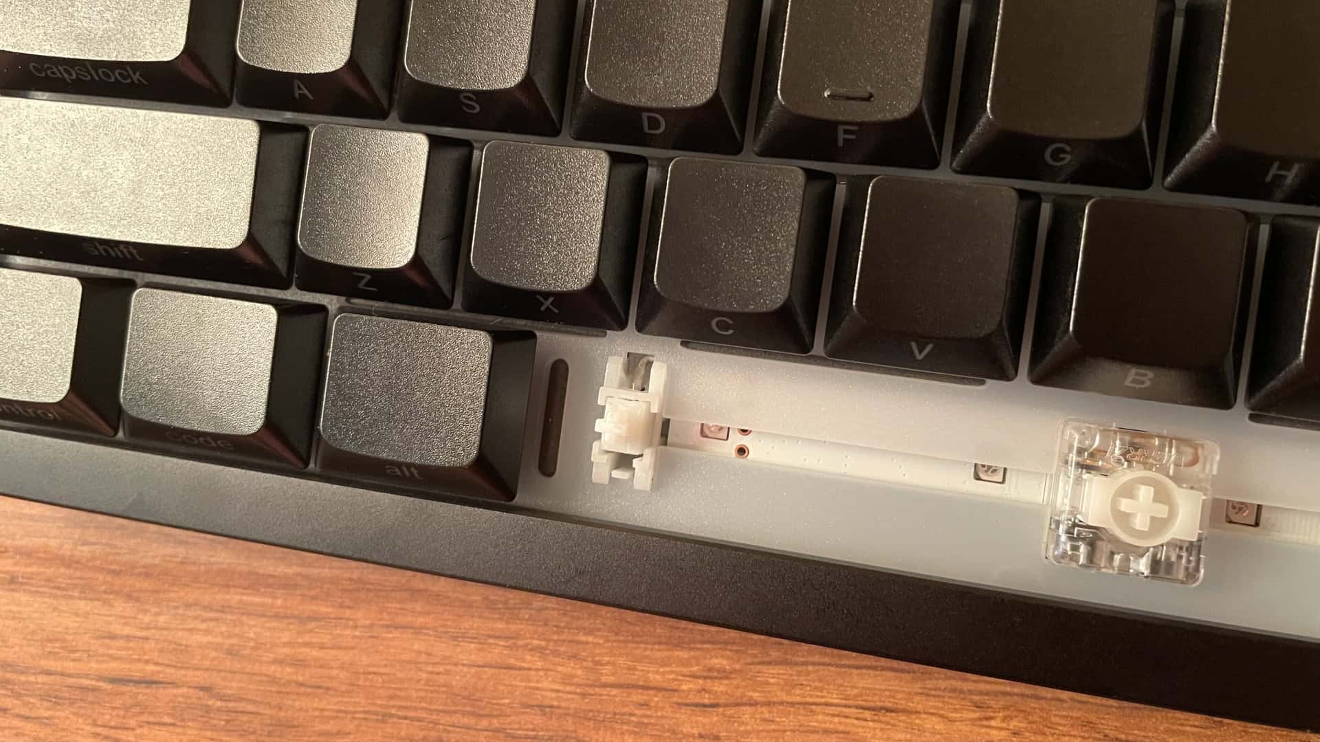 Close-up view of the lubricated stabilizers underneath the spacebar on the XVX L75 Air mechanical keyboard.