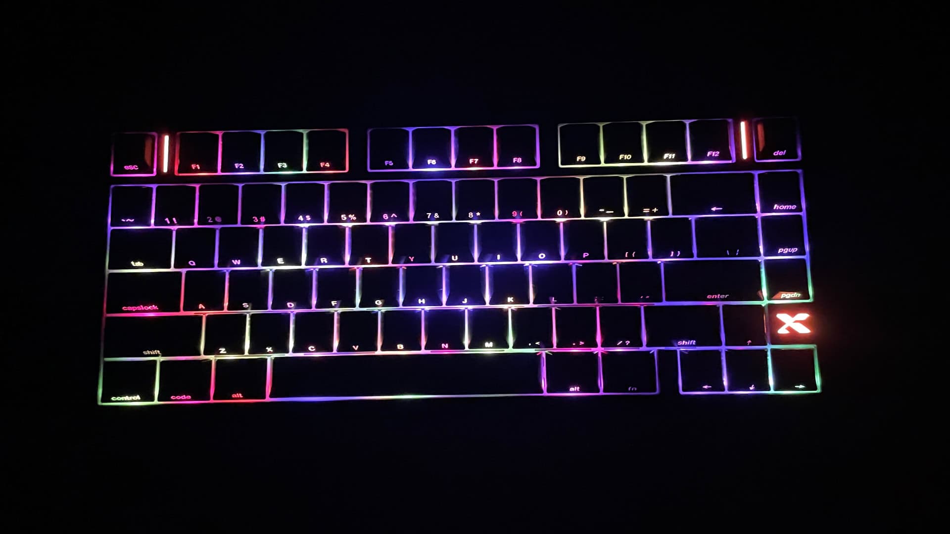 XVX L75 Air low-profile mechanical keyboard illuminated in a dark environment, showcasing its RGB backlighting and light strip accents.