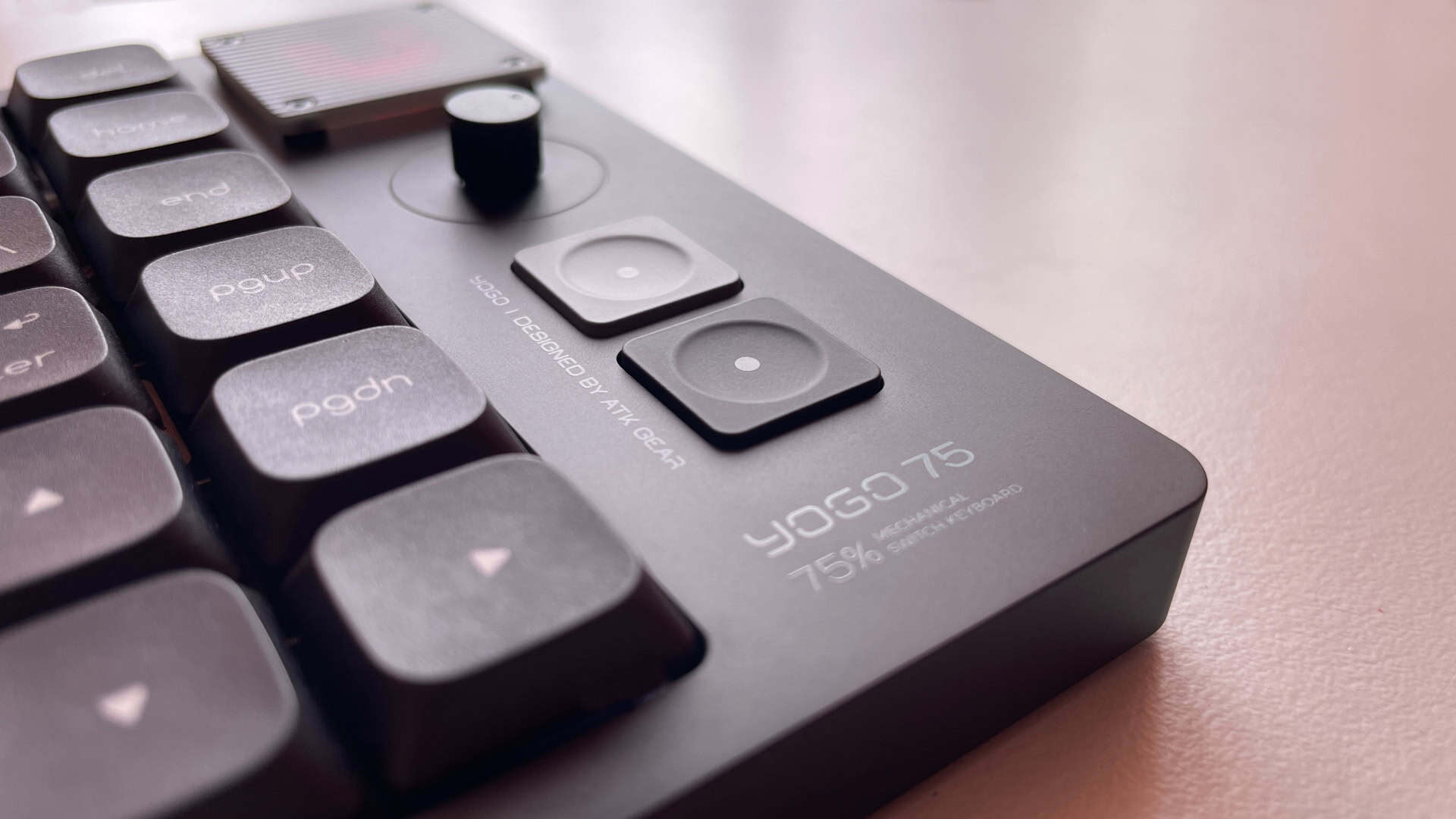The ATK Yogo 75 Pro mechanical keyboard presented in a stylish product shot, highlighting its slim profile, premium design, and unique retro-inspired features.