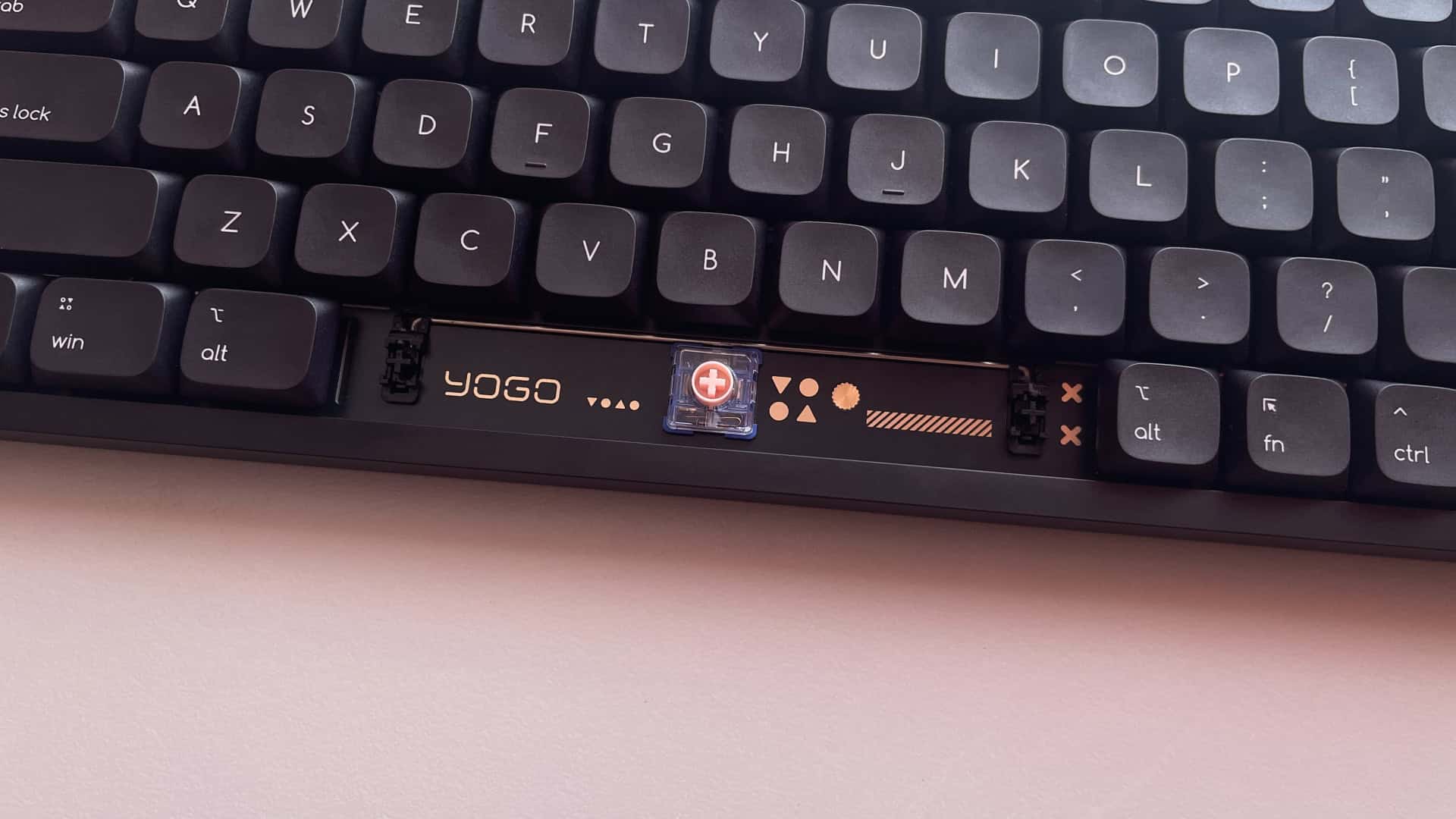 Close-up view of the ATK Yogo 75 Pro plate under the spacebar, featuring gold-colored decorative patterns on the surface.