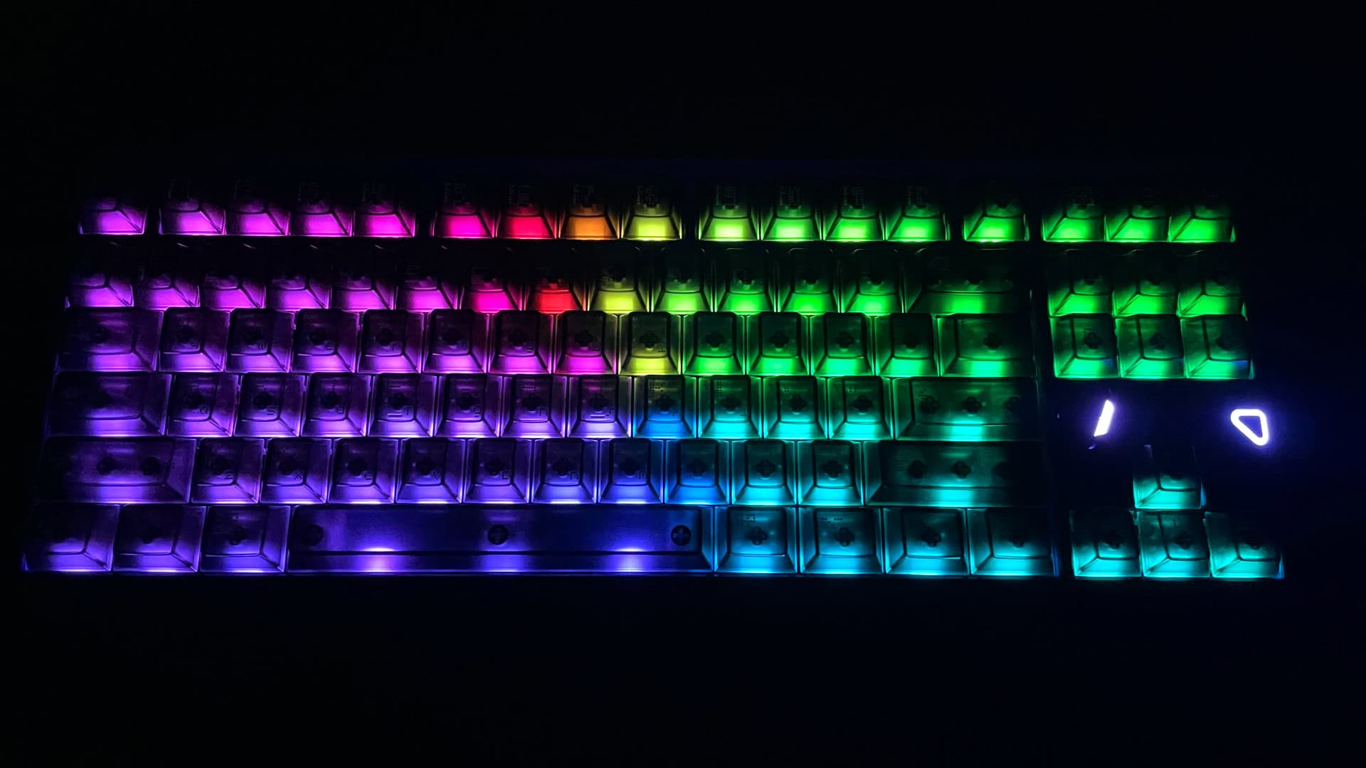 The ATK x QwertyKeys Hex80 illuminated in the dark, showcasing its RGB backlighting.