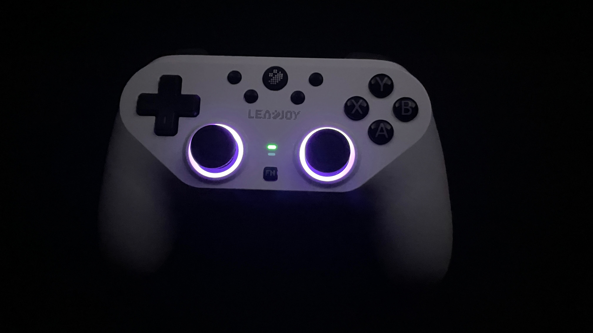 Leadjoy Saber Plus Review – $60 Symmetrical Controller with JS13 Pro TMR Sticks 16 Leadjoy Saber Plus with RGB lighting glowing around the thumbsticks in the dark.