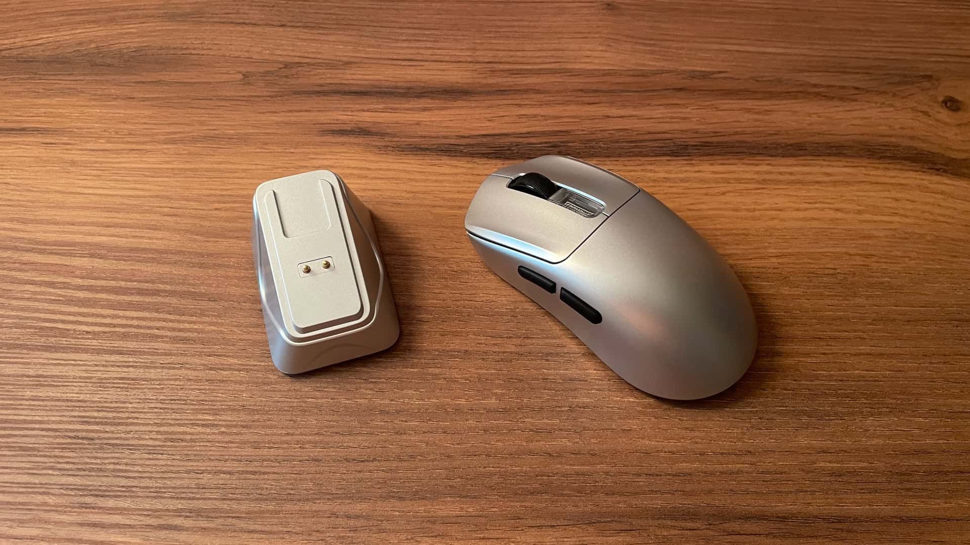 The Epomaker Nex Pro positioned next to its magnetic charging dock.