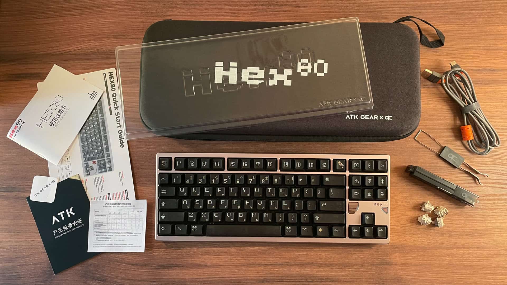 All items included with the ATK x QwertyKeys Hex80 laid out together, including the keyboard, accessories, carrying case, and documentation.