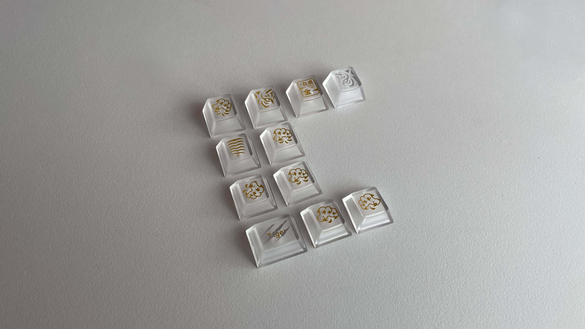 All 11 novelty keycaps from the XVX White Tiger set arranged together, showing their different designs and graphics.