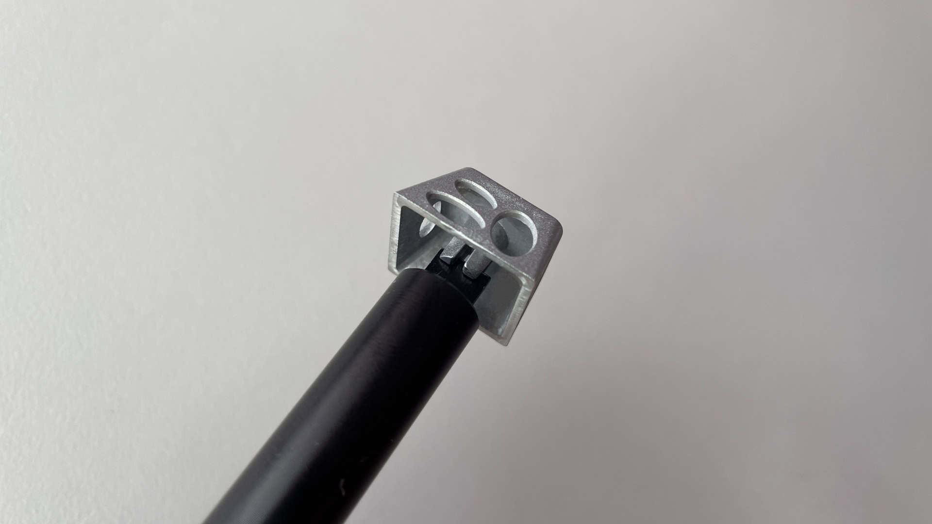 The stem adjustment tool inserted into the stem of an aluminum artisan keycap to widen it and fine-tune the fit.