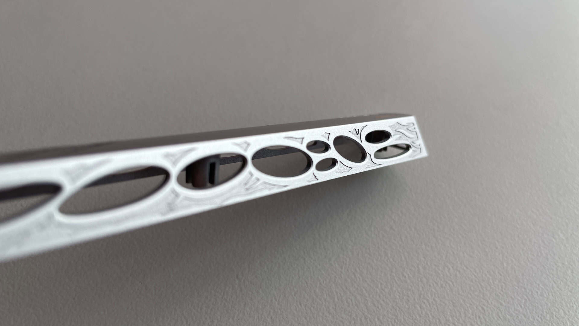 Close-up of the aluminum Spacebar featuring an intricate engraved pattern with an ancient, ornamental feel.
