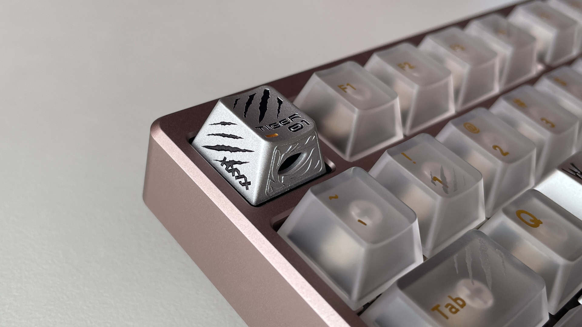 An aluminum artisan keycap installed on an ATK × QK Hex80 mechanical keyboard.