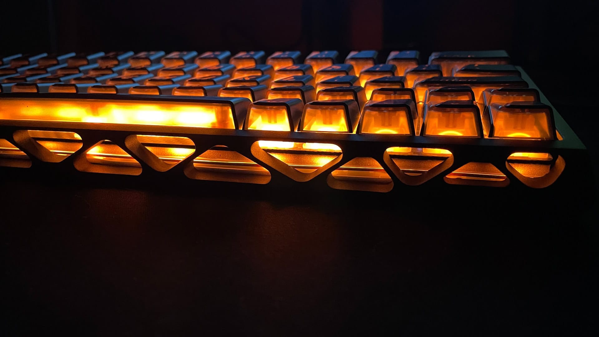 Orange RGB lighting glowing through the skeletonized case of the XVX Trooper63 HE, creating the appearance of a fire inside.