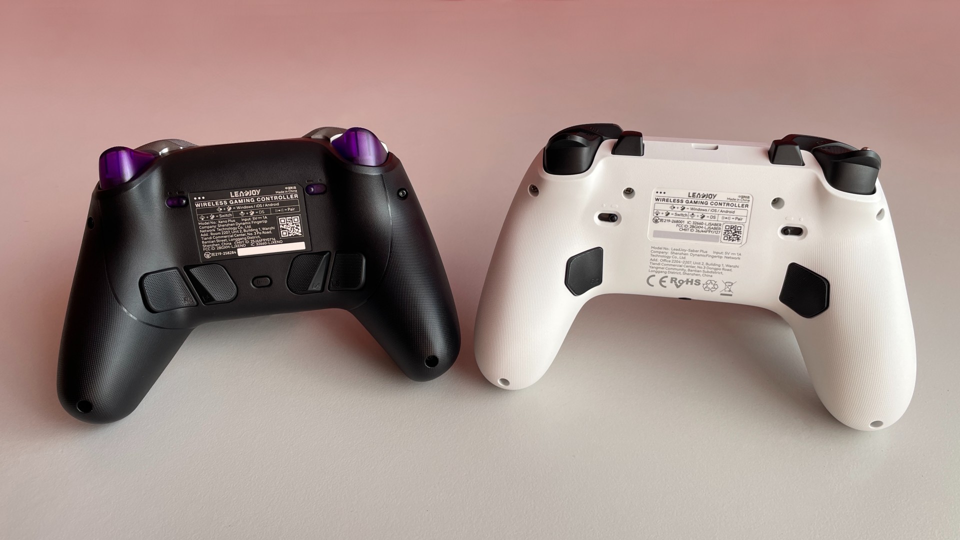 Leadjoy Xeno Plus vs Leadjoy Saber Plus: Same DNA, Same $60Price, Different Paths 4 Back view of the Leadjoy Xeno Plus and Leadjoy Saber Plus controllers placed side by side.