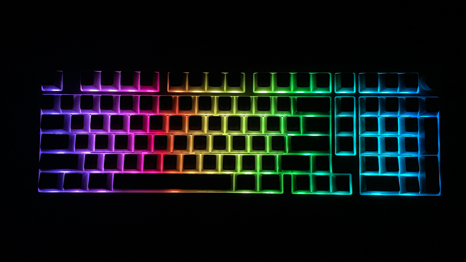 Epomaker Galaxy100 Review – A $100 Aluminum Keyboard with a Numpad and a Knob! 8 Epomaker Galaxy100 mechanical keyboard with its RGB backlighting illuminated in a dark room.