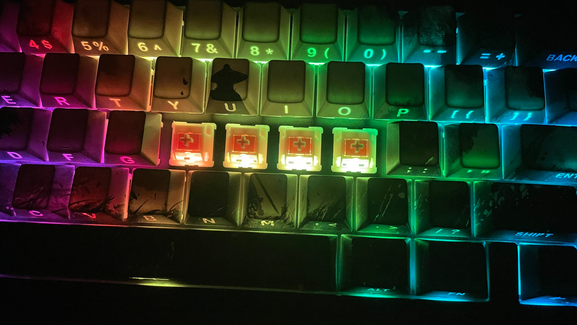 Epomaker Roseveil switches installed in a keyboard in the dark, showing how the backlight shines through their housings.