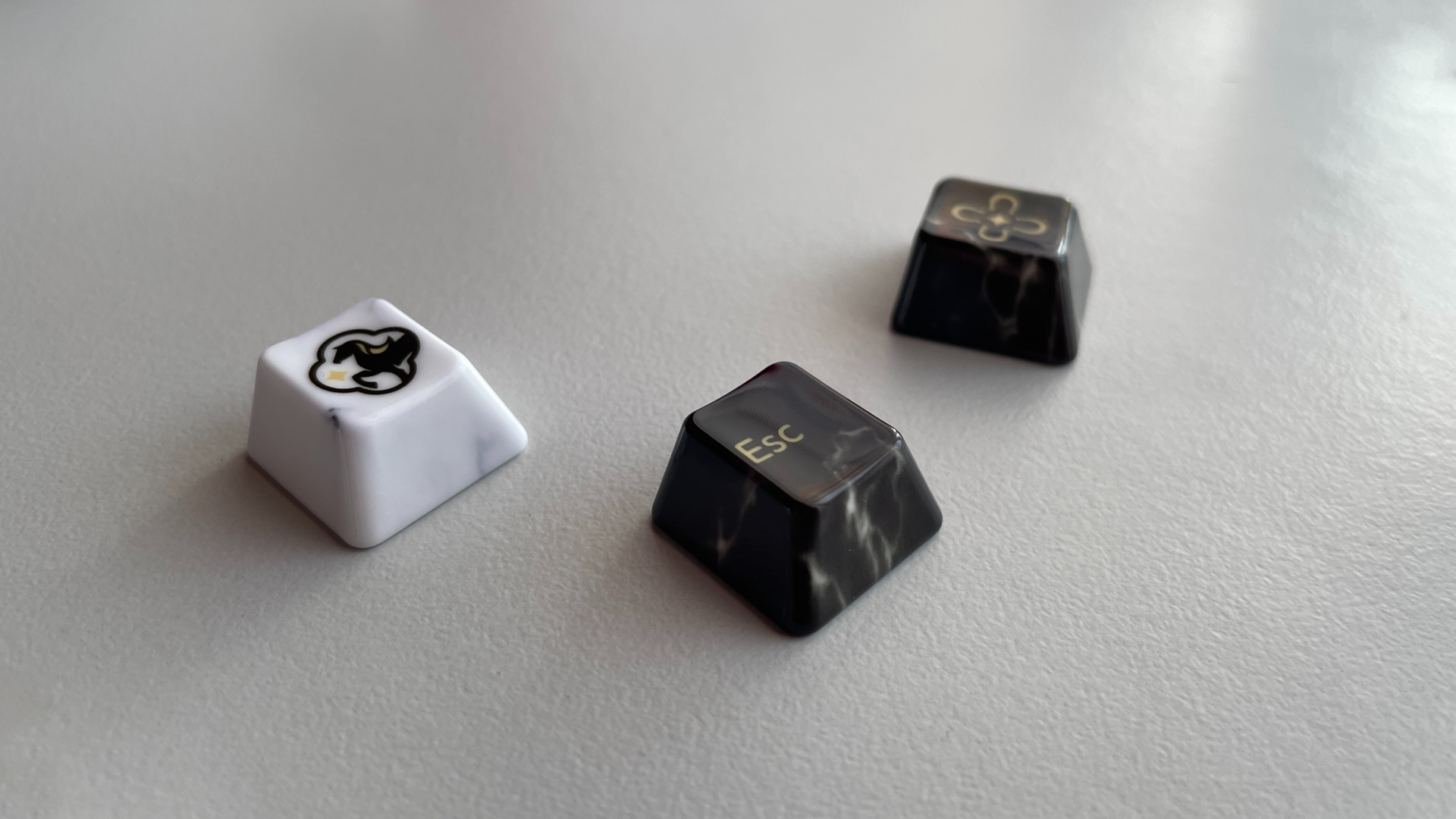 XVX Ceramic Keycaps Review: Year of the Horse Keycap Set 12 Several black accent keycaps from the XVX Year of the Horse set, showing their marble-like veining.