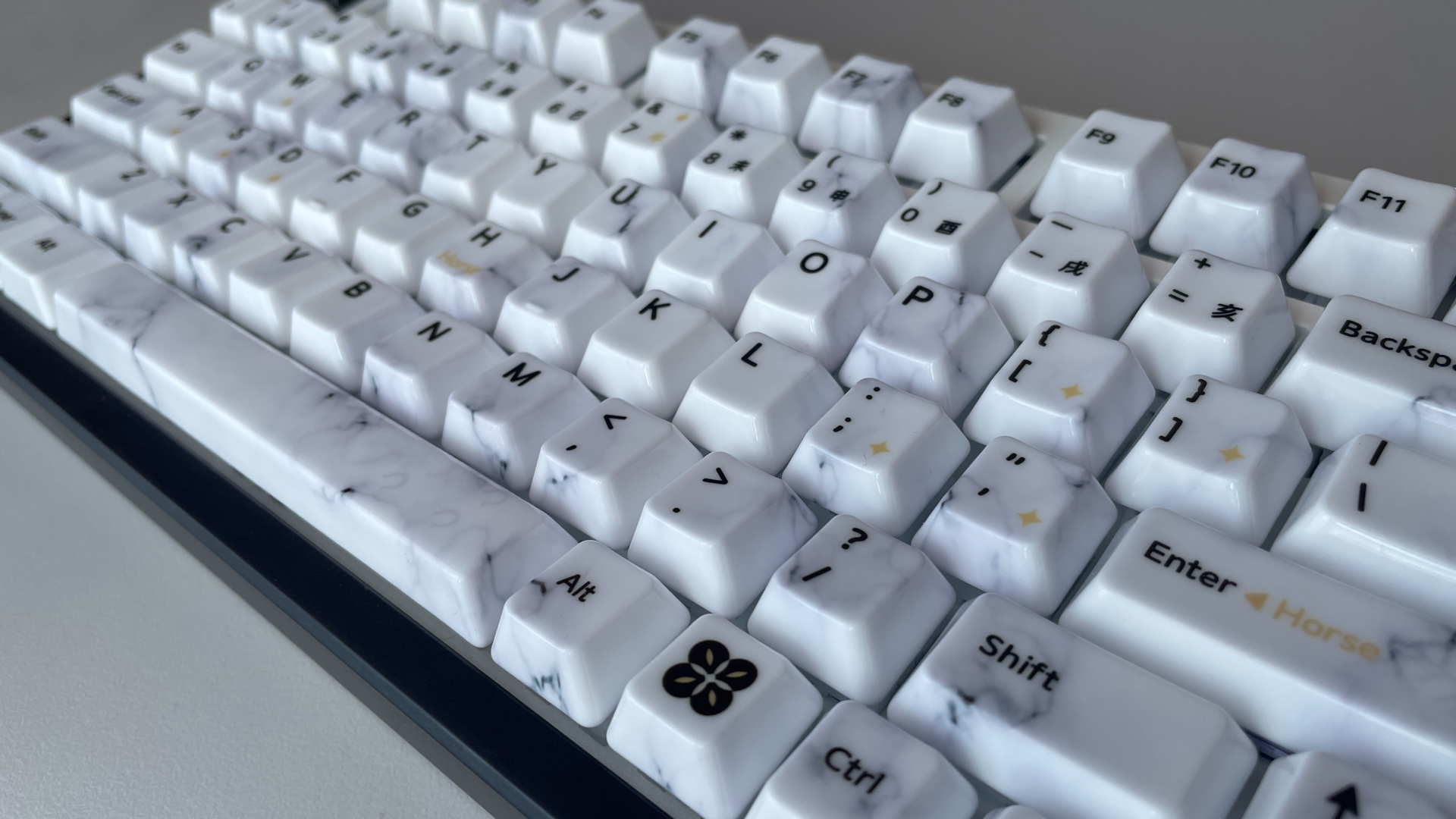 XVX Ceramic Keycaps Review: Year of the Horse Keycap Set 9 Close-up of XVX Year of the Horse ceramic keycaps, showing the marble-like veining on their surface.