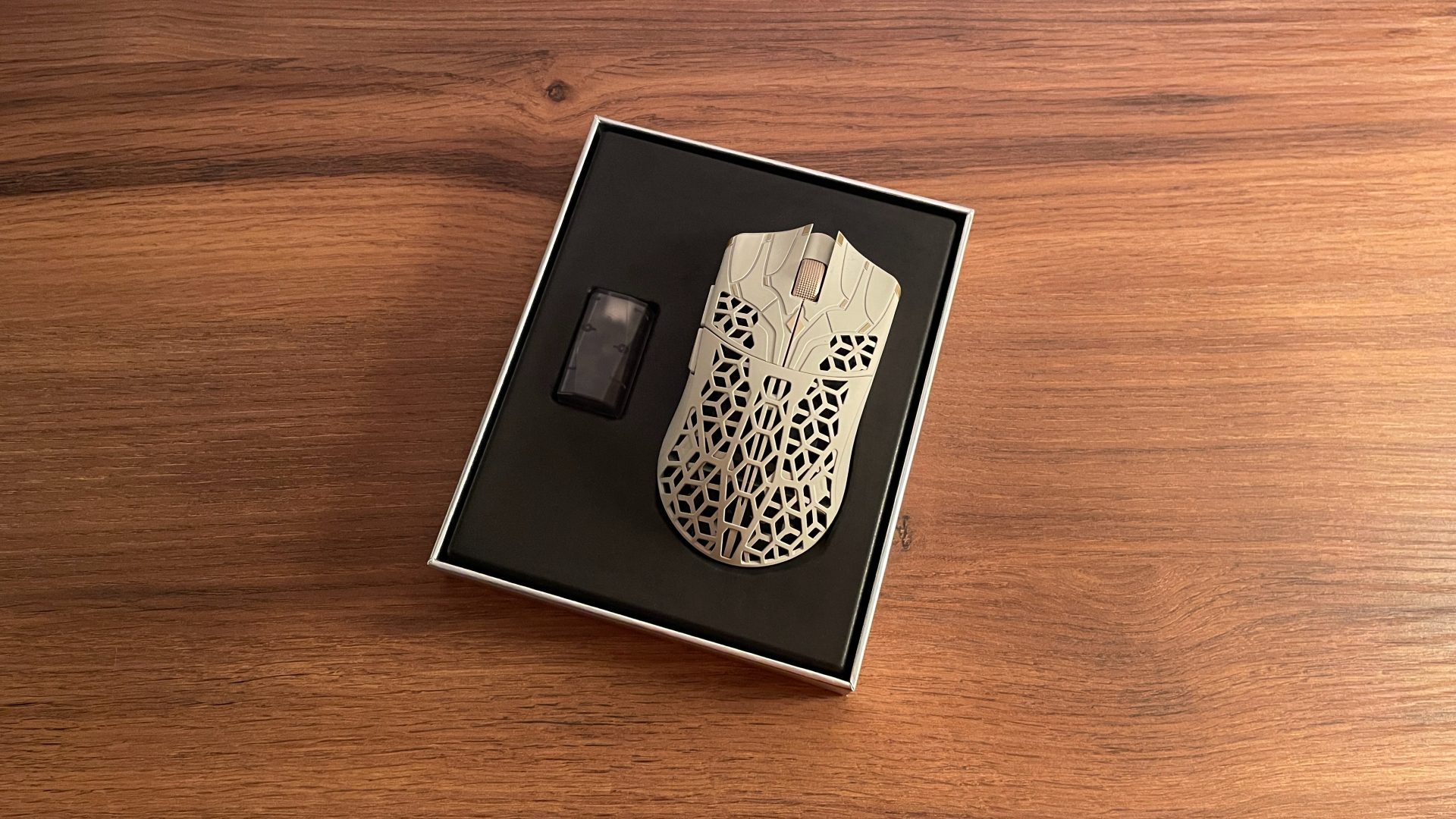 The ATK Phantom gaming mouse inside its opened box, with the 2.4 GHz dongle placed beside it.