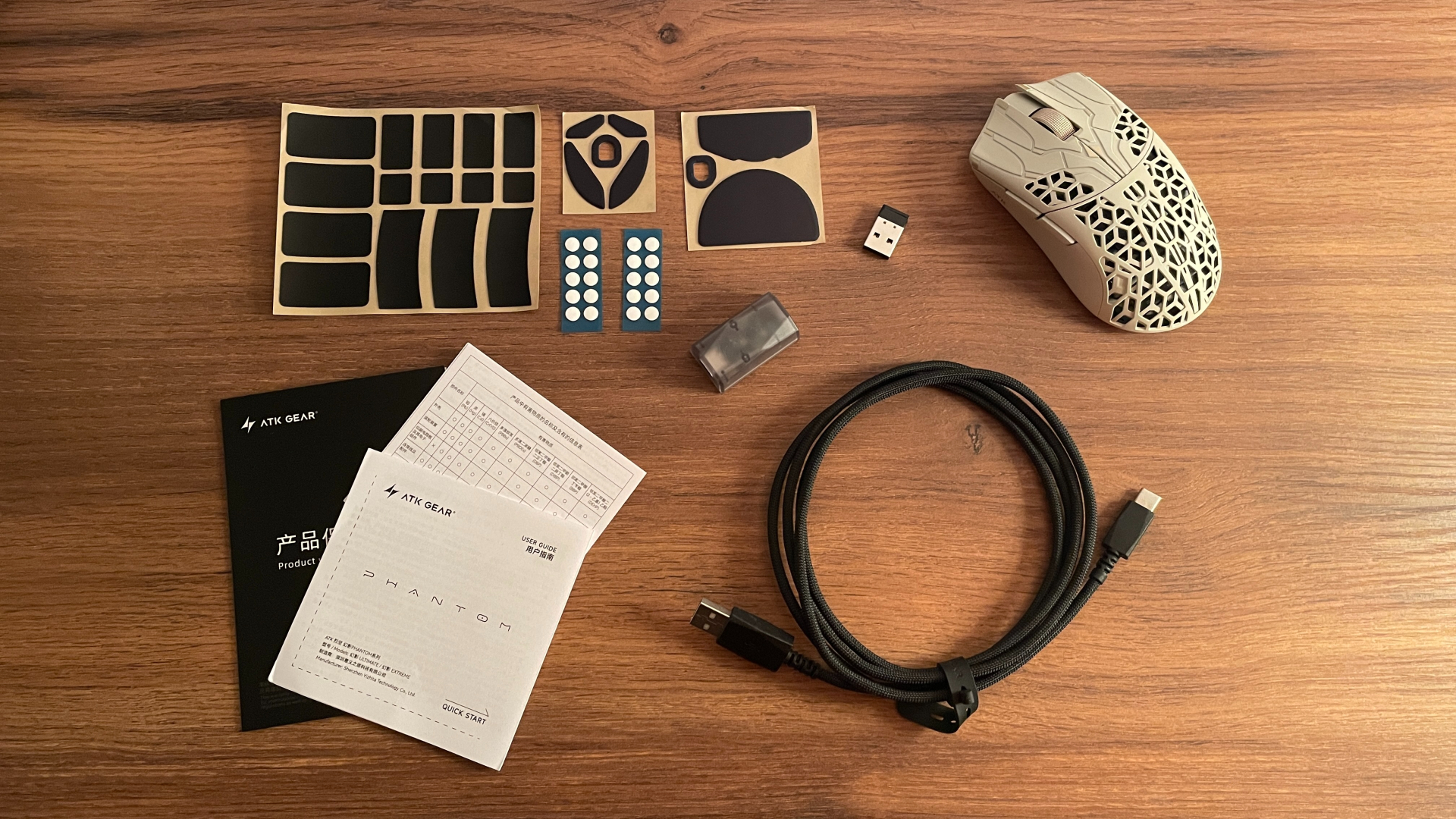 The full accessory bundle included with the ATK Phantom gaming mouse.