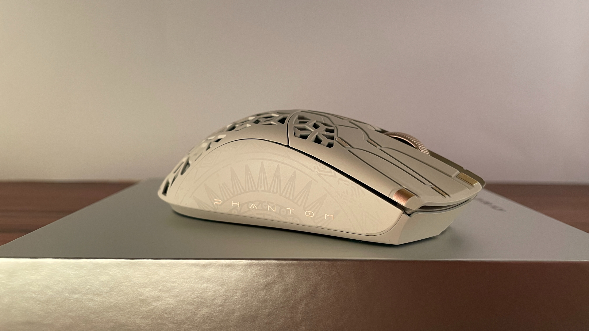 Side view of the ATK Phantom gaming mouse, showing the decorative pattern along the shell.