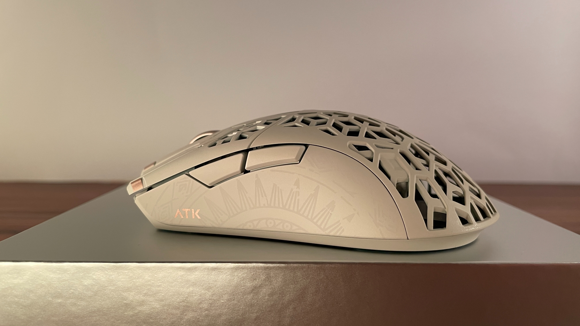 Side view of the ATK Phantom gaming mouse from the opposite side, showing the decorative pattern on the shell.