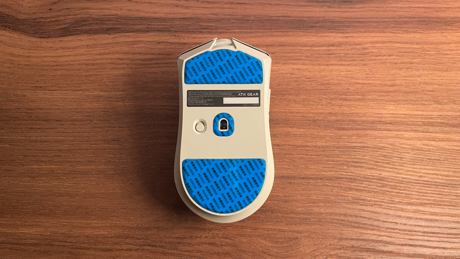 Bottom view of the ATK Phantom gaming mouse with the protective films still on the skates.