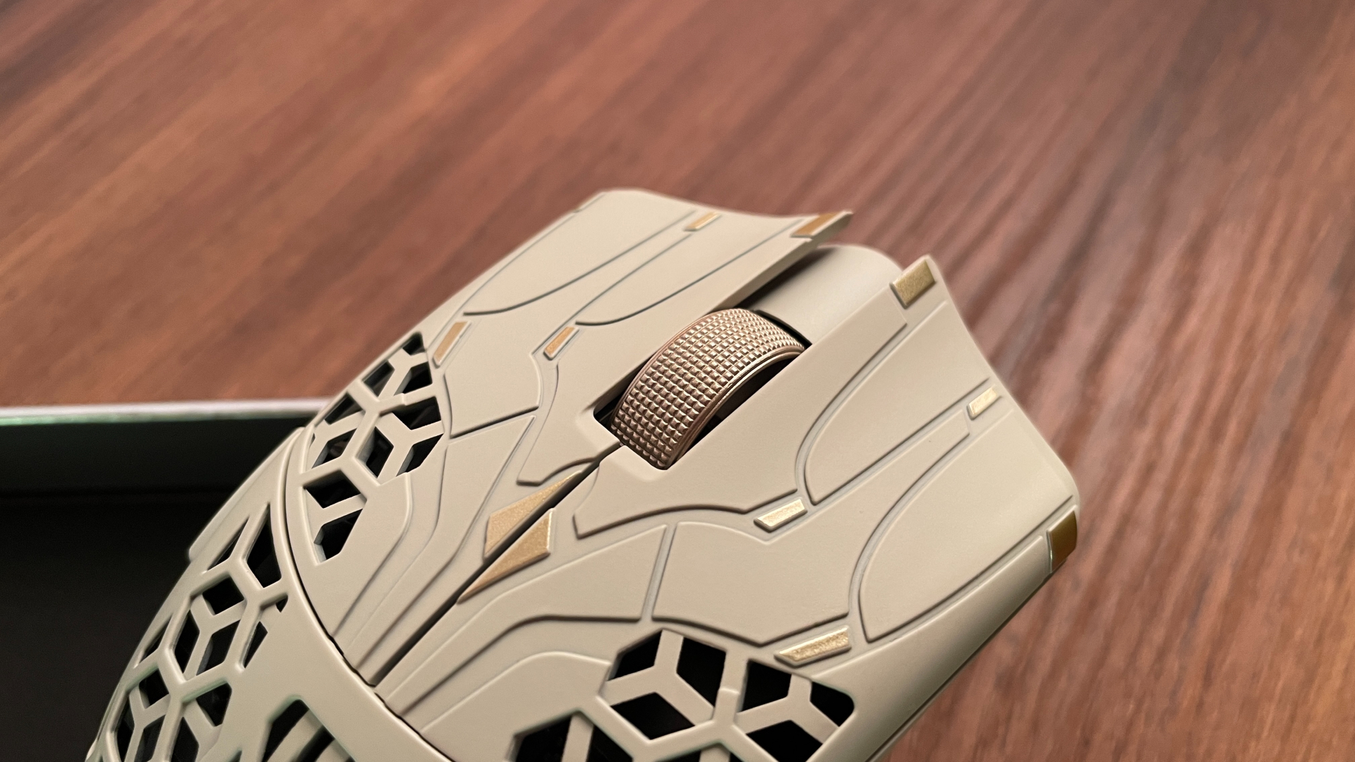 Close-up of the ATK Phantom gaming mouse, focusing on the gold scroll wheel.