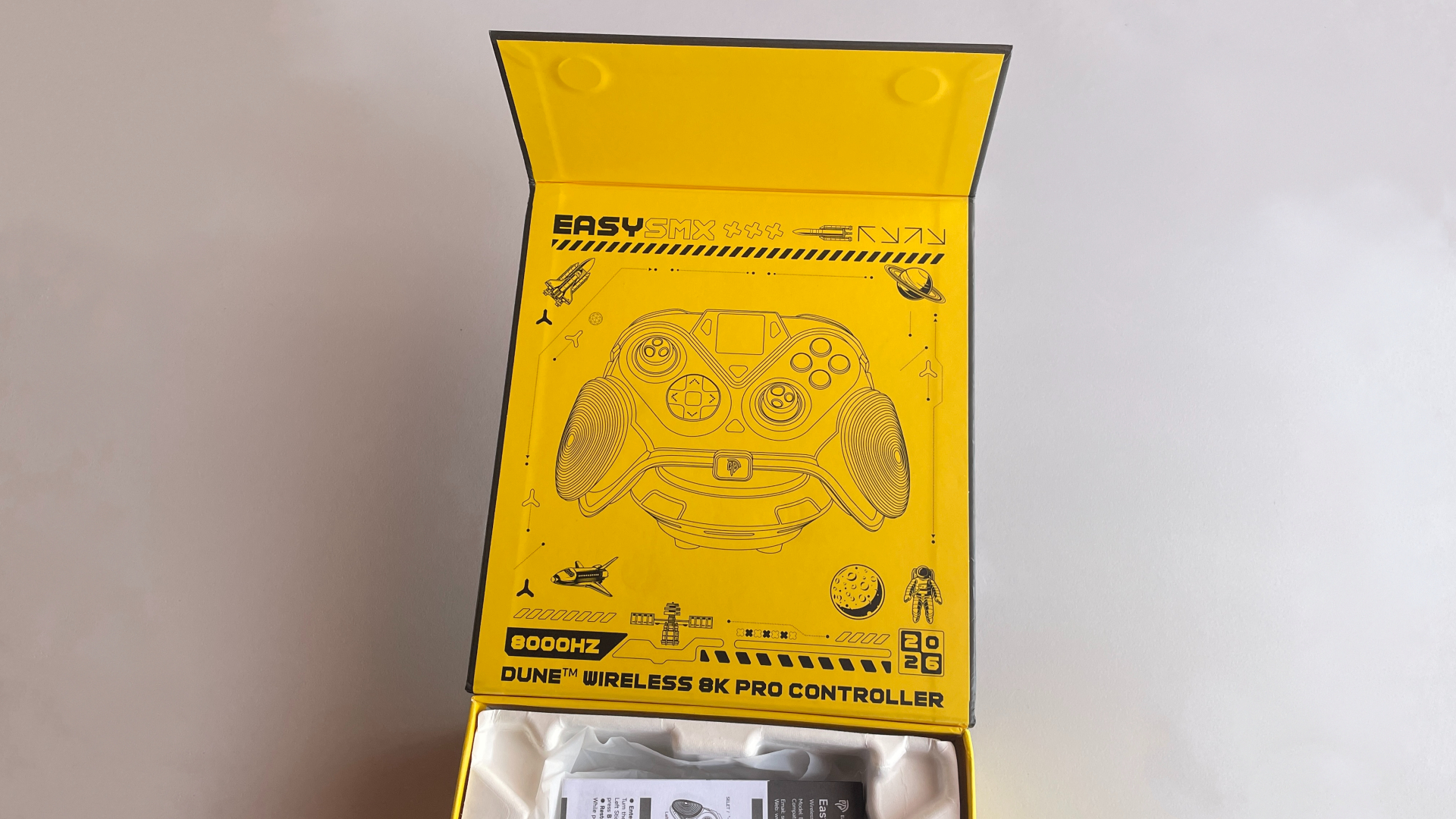EasySMX Dune 8K Review – A Close Encounter with a One-of-a-Kind Controller 5 Space-themed illustration featuring the EasySMX Dune 8K on the inside of the box lid.