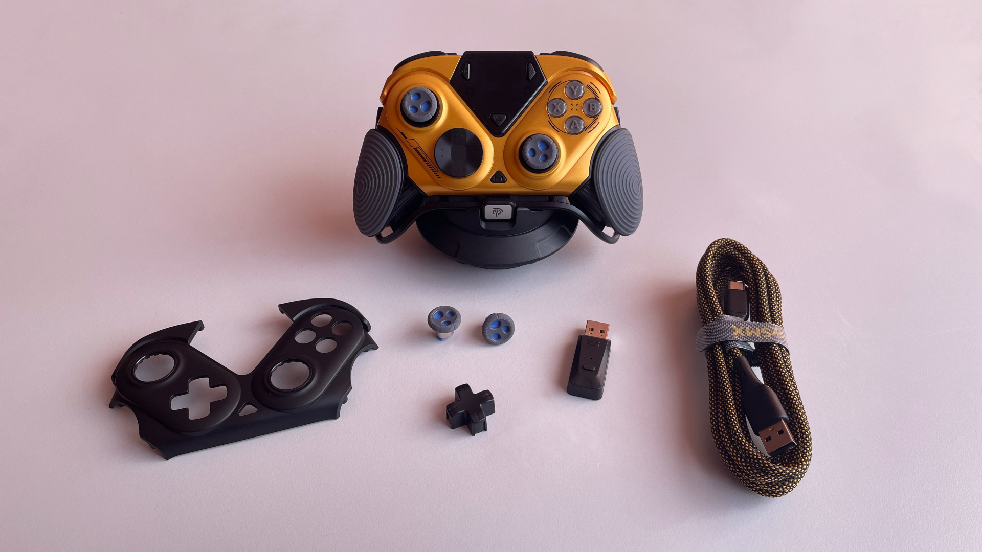 EasySMX Dune 8K Review – A Close Encounter with a One-of-a-Kind Controller 6 EasySMX Dune 8K controller with its charging dock, wireless dongle, extra faceplate, cross-style D-pad cap, taller thumbsticks, braided USB cable.